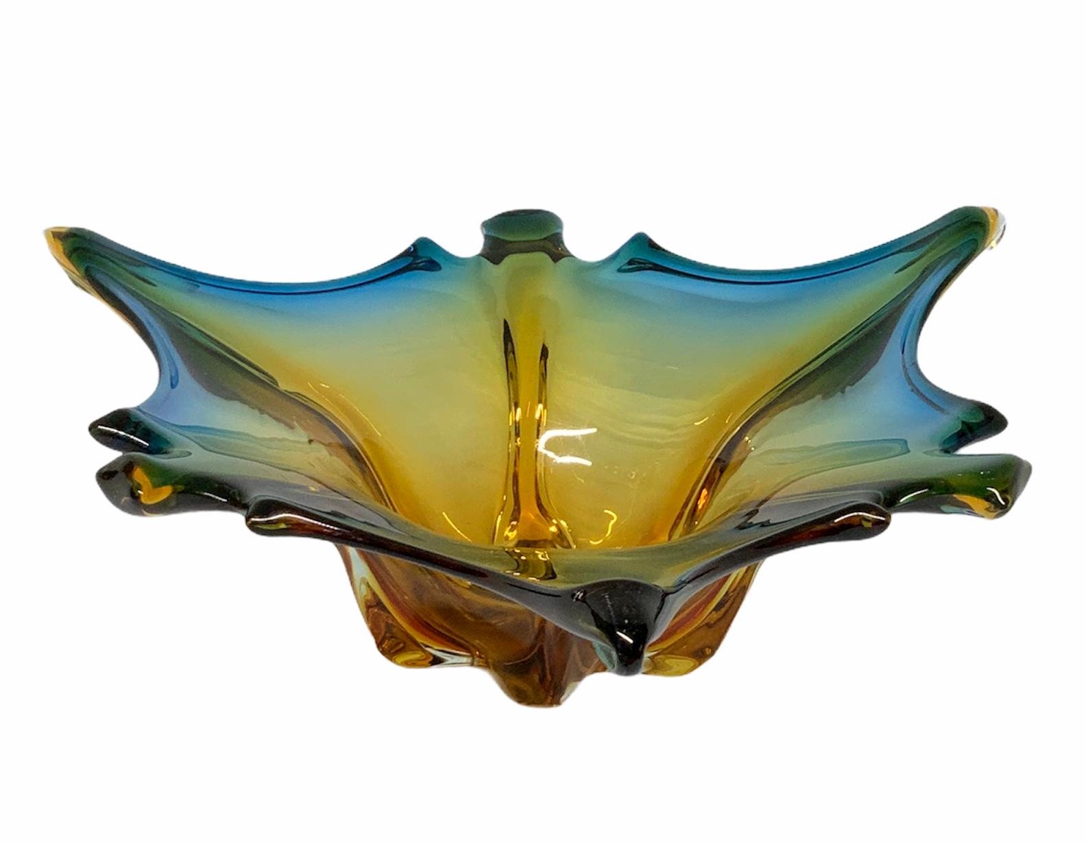 This is a vibrant tricolor asymmetric shaped large Murano bowl. Bright blue, green and yellow colors define the glass. This bowl piece is shaped as a maple leaf or a starfish.