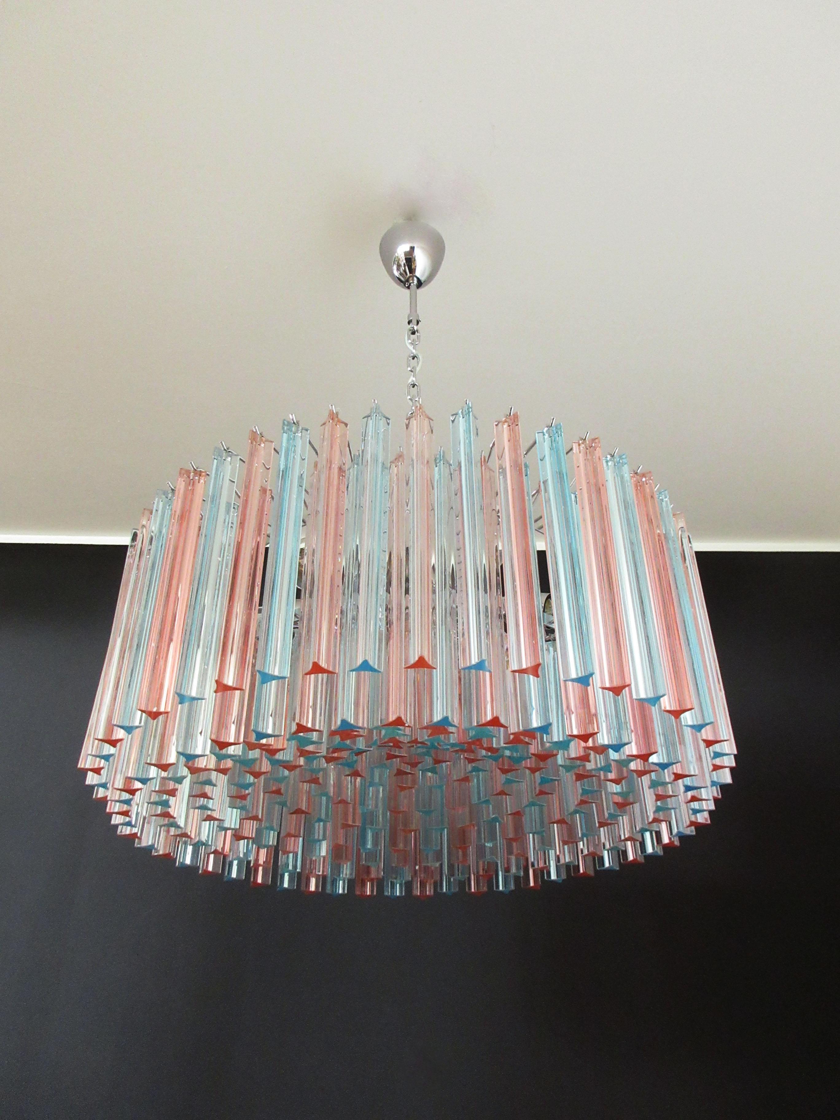 A magnificent Murano glass chandelier, 265 pink and blue triedri on crome frame. This large midcentury Italian chandelier is truly a timeless classic.
Period: late 20th century
Dimensions: 43.30 inches (110 cm) height with chain; 15.75 inches (40