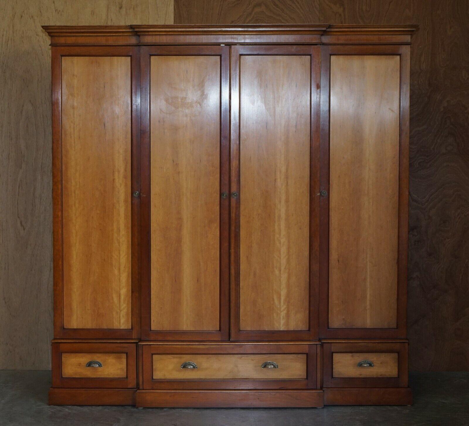 We are delighted to offer for sale this lovely large Cherrywood and Walnut breakfront wardrobe with drawers to the base.

A very large and well made piece offering huge amounts of storage, you have one large central hanging wardrobe which has one