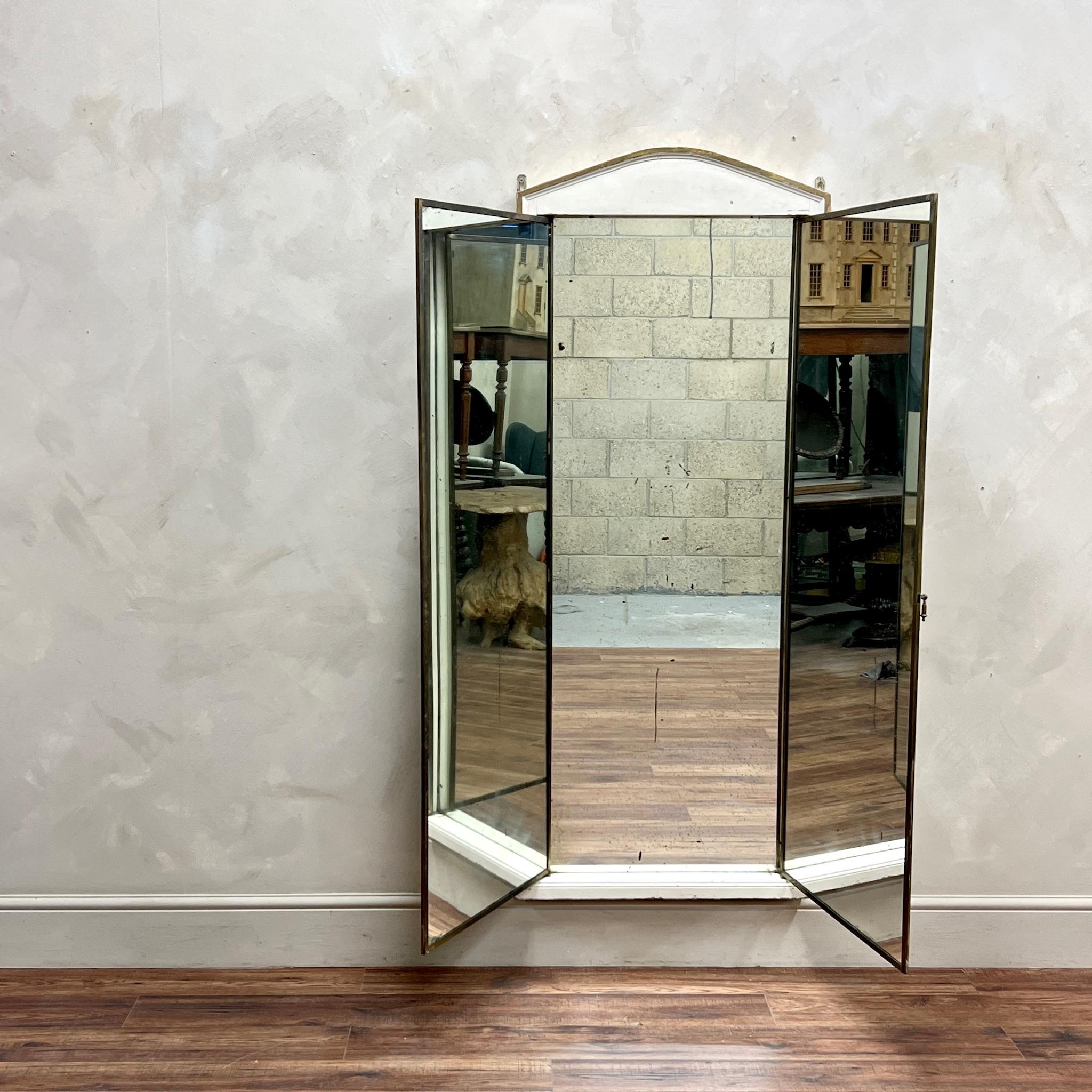 Large Scale Brass Framed Miroir Brot.
Triptych Mirror.
Inset into an unusual, wooden painted surround with rare shape portico. This could be scraped back or over-painted.
Gentle foxing to original mirror plate.

France, circa 1920.

Height: