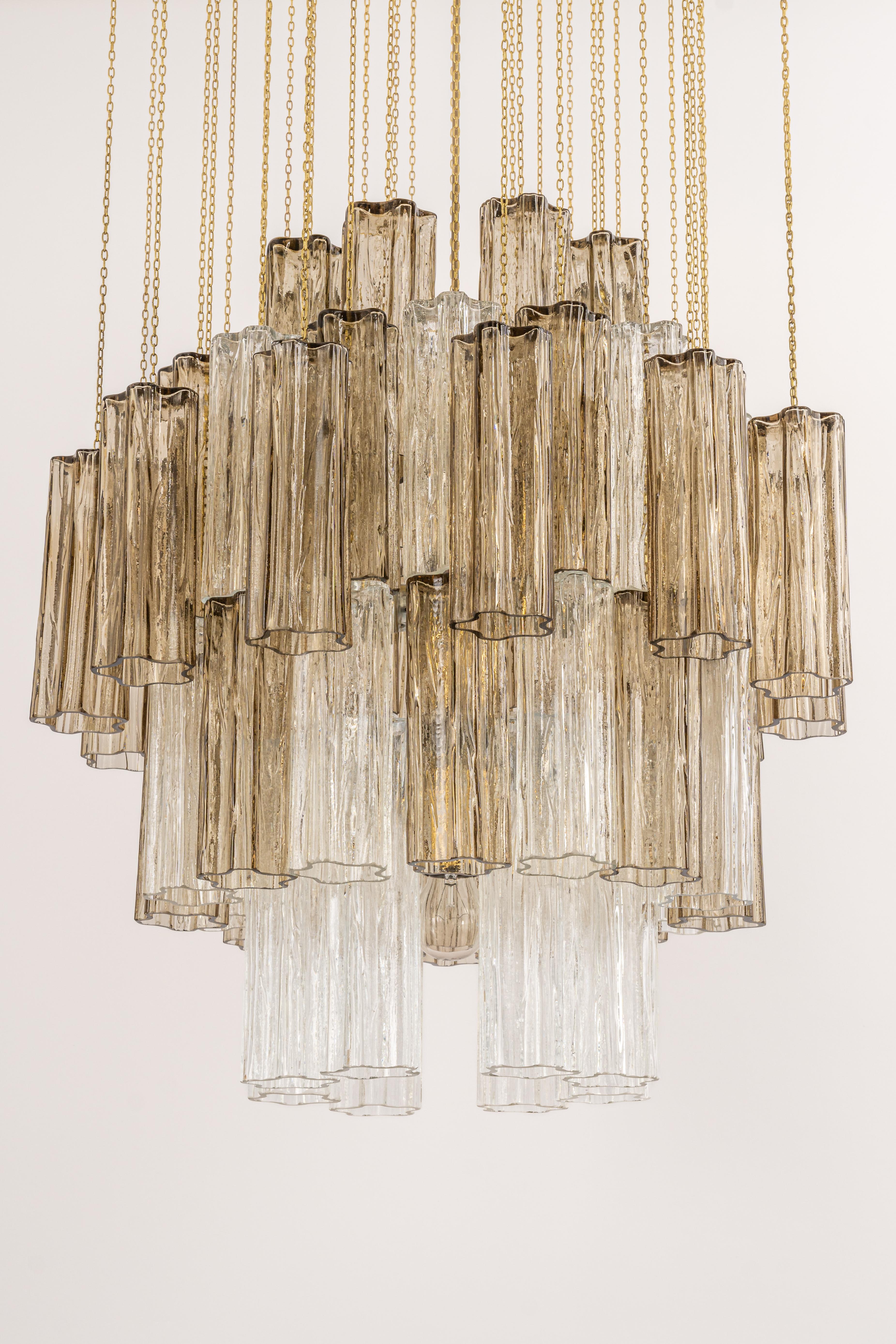 Stunning Murano glass chandelier designed by Venini for Kalmar, 1960s
Three tiers brass structure gather many structured glasses, beautifully refracting the light very heavy quality.

High quality and in very good condition. Cleaned, well-wired