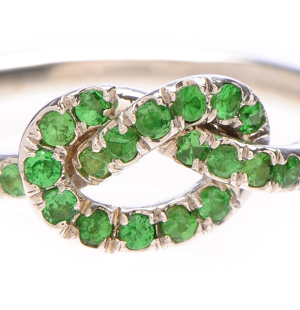 Signature Love Knot ring, and the unique Tsavorite stones are what makes this really special. 

18k white gold 
engraved 