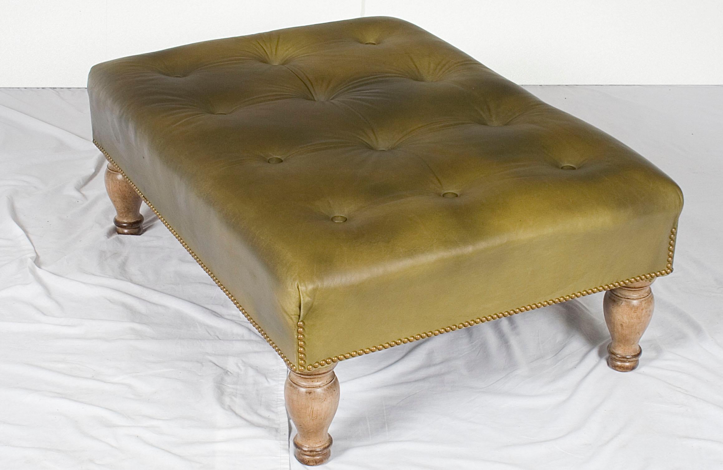This particular vintage large leather ottoman possesses a depth and character than can only be acquired through years of life. The supple leather exudes charm and the turned legs provide wonderful support.

The underneath of this piece bears the