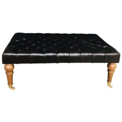 Large Tufted Leather Ottoman on Mahogany Legs with Solid Brass Wheeled Sabots