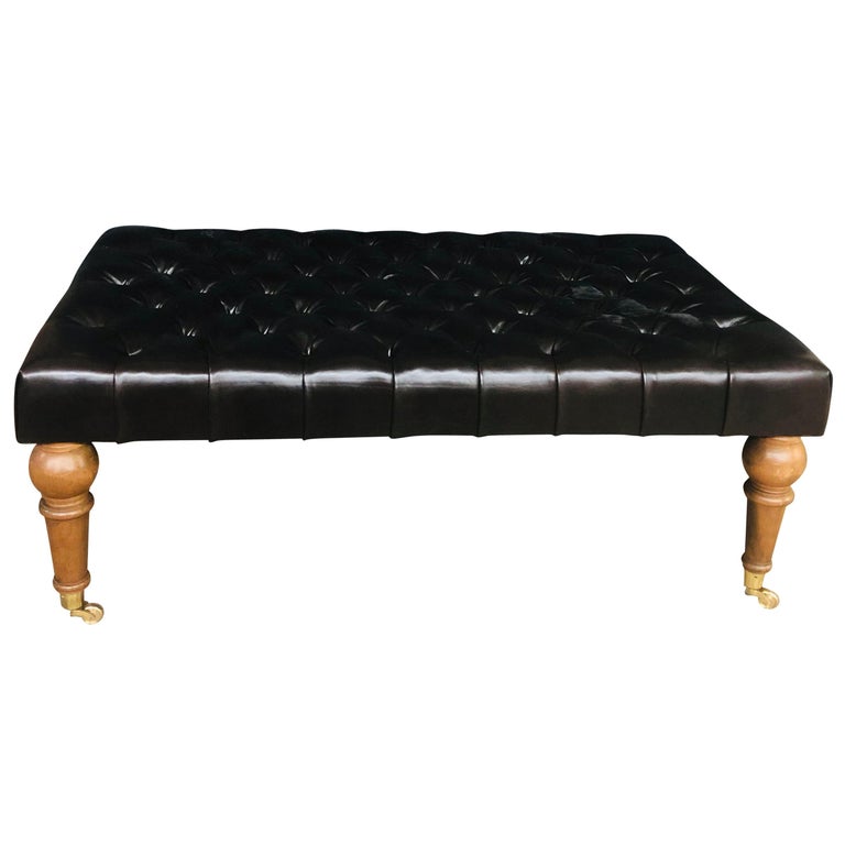 Large Tufted Leather Ottoman on Mahogany Legs with Solid Brass Wheeled