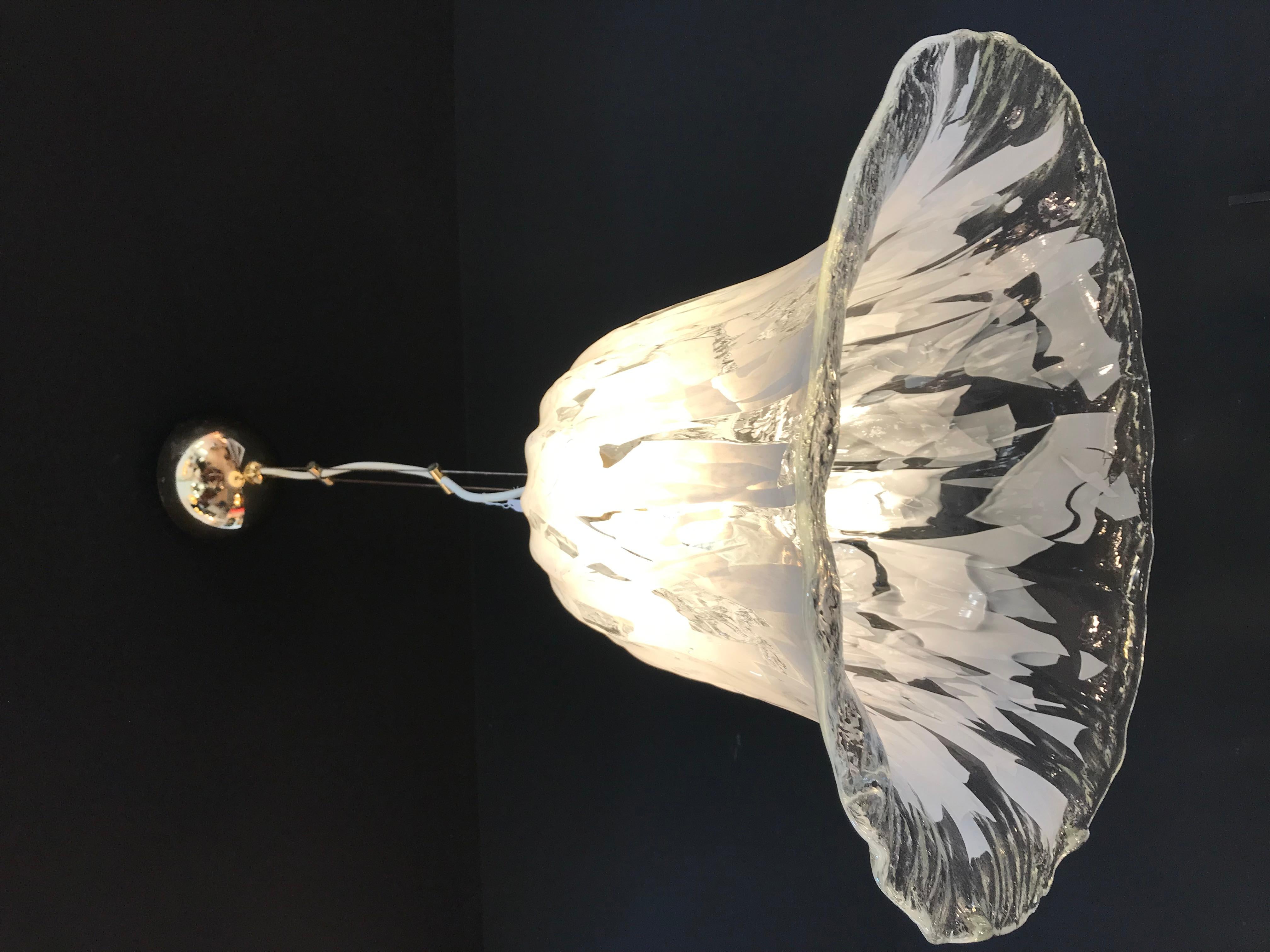 Impressive sculptural Mid-Century modernist Murano glass designed by Carlo Nason and executed by Mazzega, Italy, circa 1970. The shade is a large Tulip like flower with textured clear and white tinted glass with a chrome ceiling attachment.  

Total