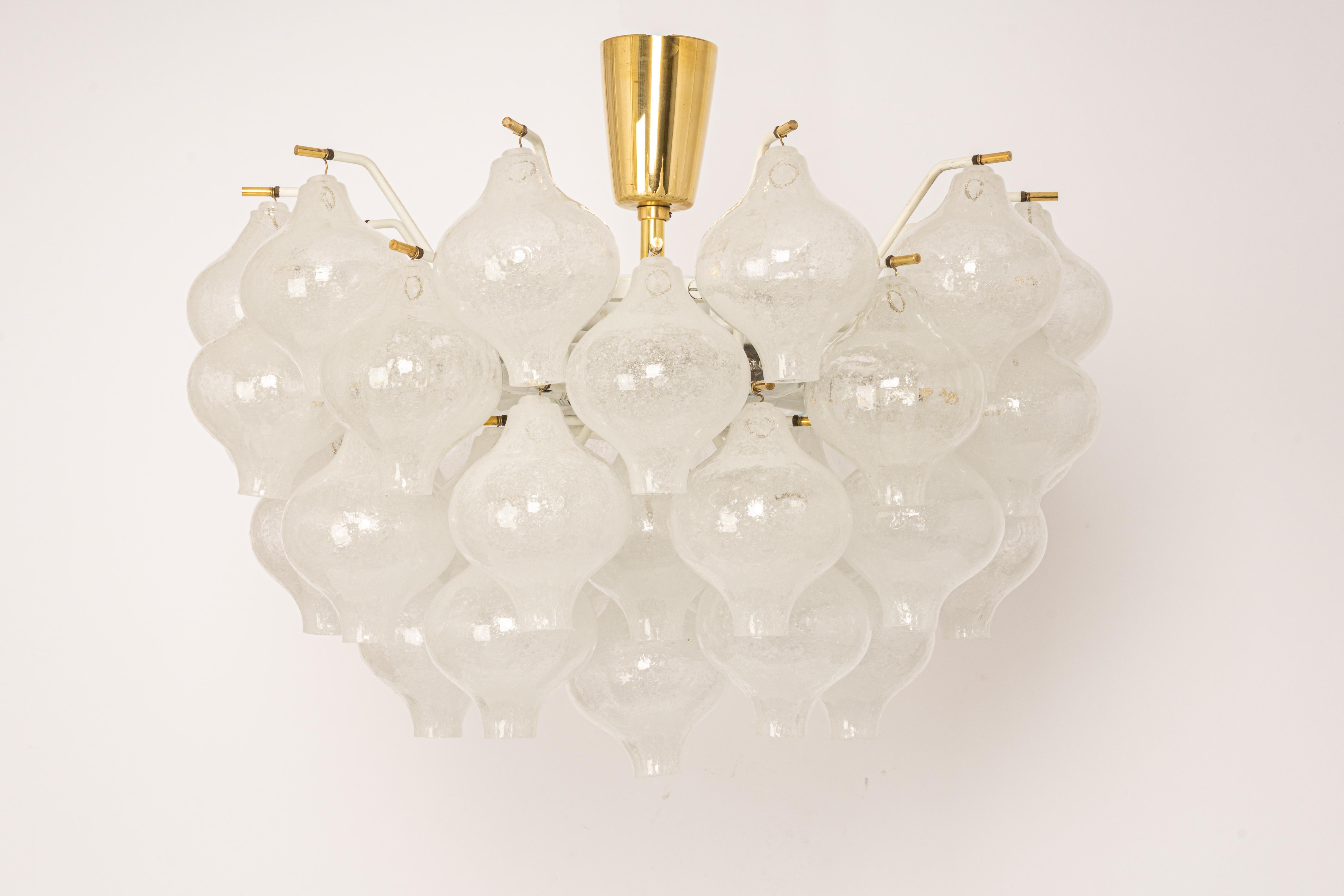 Wonderful onion-shaped -Tulipan glass chandelier or flush mount. A large number of hand-blown glasses are suspended on a white-painted metal frame and brass center rod.
Best of design from the 1960s by Kalmar, Austria. High quality of the