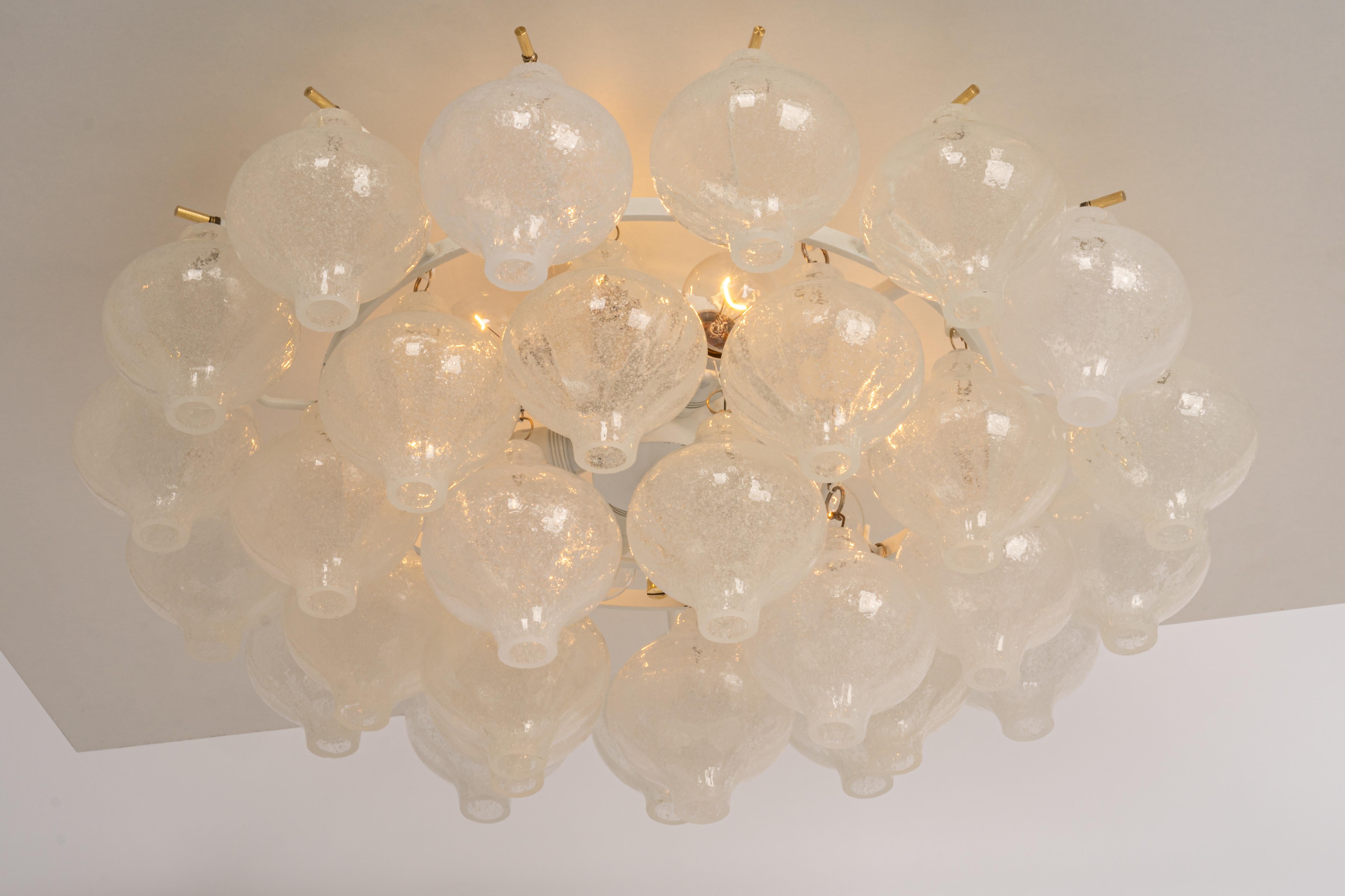 Wonderful onion-shaped -Tulipan glass chandelier. 30 hand-blown glasses suspended on a white painted metal frame.
Best of design from the 1960s by Kalmar, Austria. High quality of the materials.

Sockets: The chandelier takes 9 small screw base