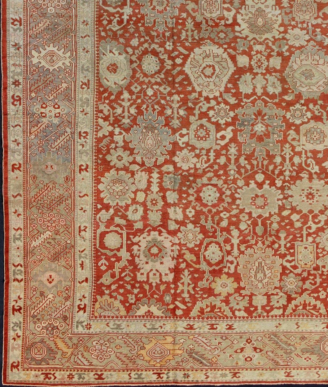 Large antique Oushak rug with all-over floral design in soft vermilion red, taupe, light green, gray and light orange rug/G-0102, Turkish antique Oushak.

Measures: 14'8 x 18'8

This magnificent Oushak carpet beautifully illustrates the stunning
