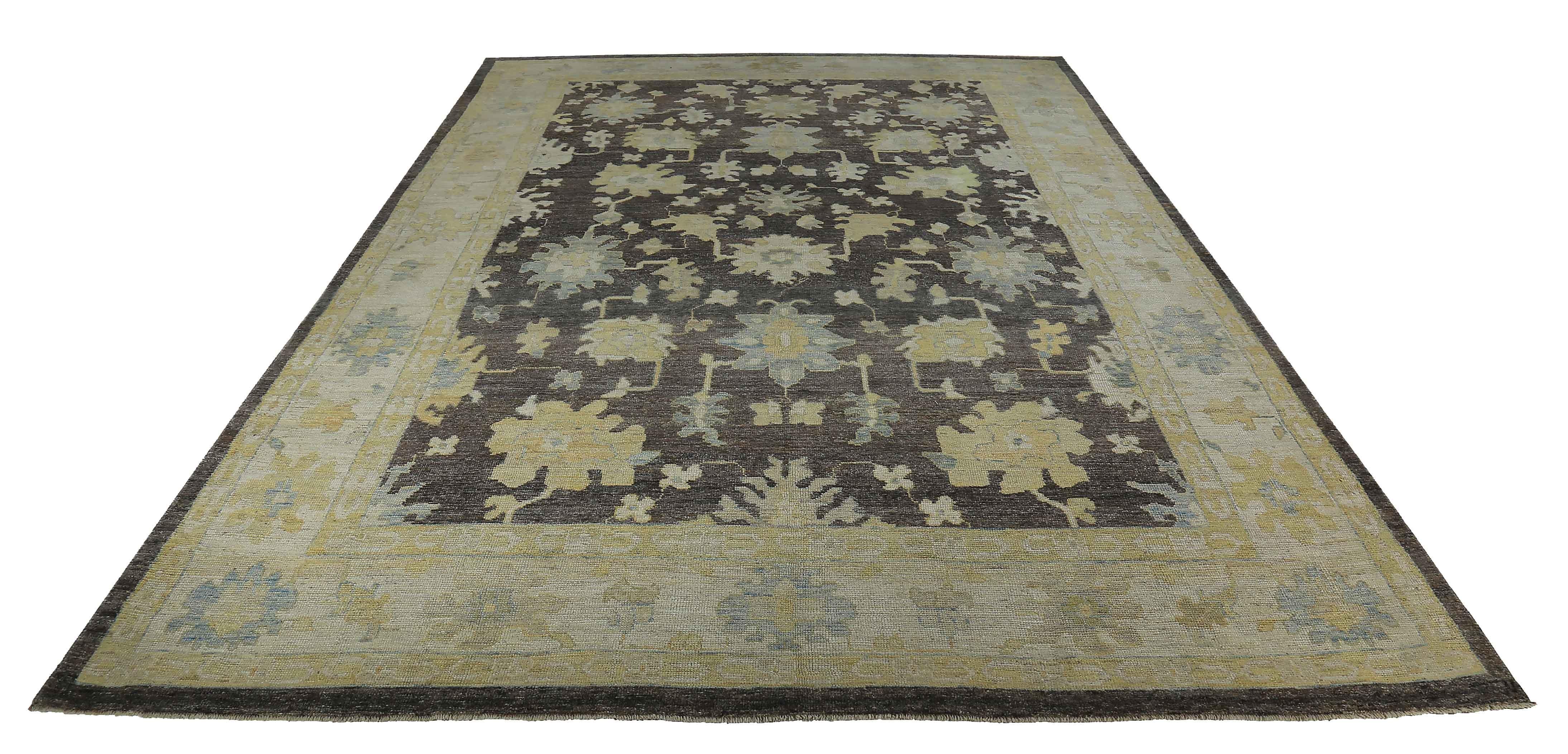 New Turkish rug made of handwoven sheep’s wool of the finest quality. It’s colored with organic vegetable dyes that are certified safe for humans and pets alike. It features blue and gold floral details on a brown field. Flower patterns are commonly