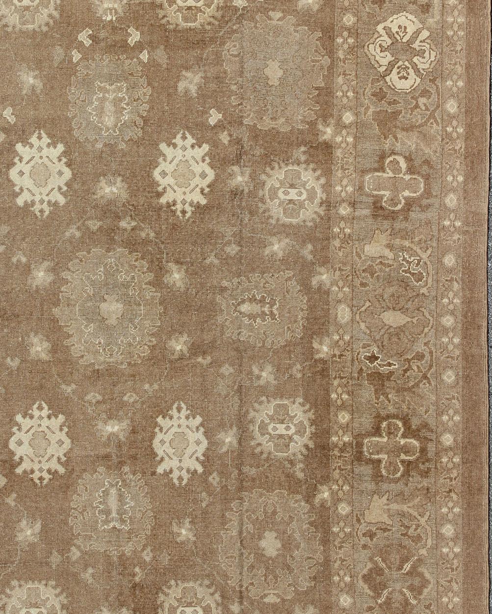 Hand-Knotted Large Vintage Turkish Rug in Light Brown Field, Taupe, Ivory and Earth Tones   For Sale