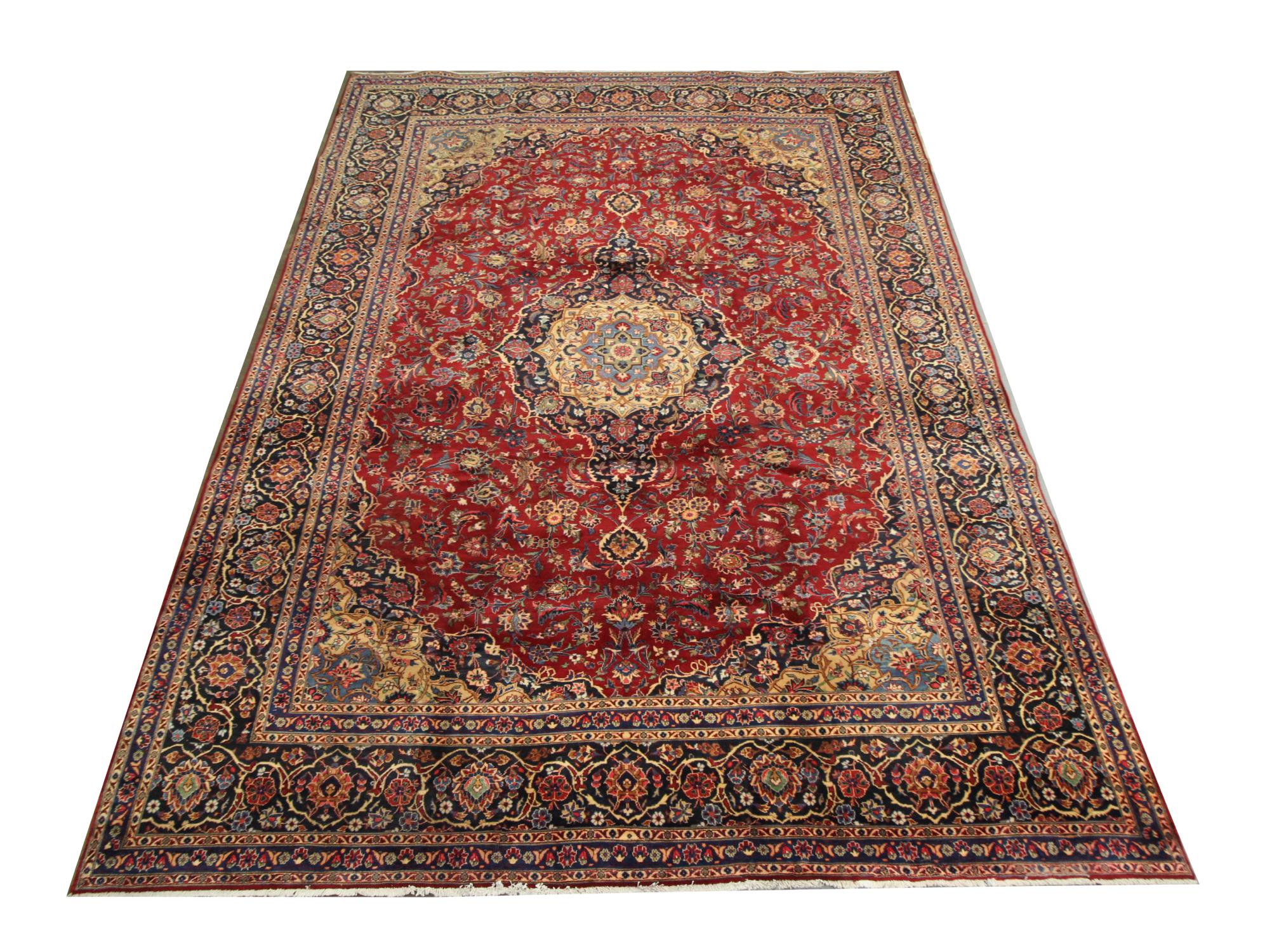 This luxurious carpet has been woven with a rich wine red background with cream, blue, green and pink accents that make up the intricate, highly-decorative medallion and surrounding design. The floating medallion and complex surrounding patterns