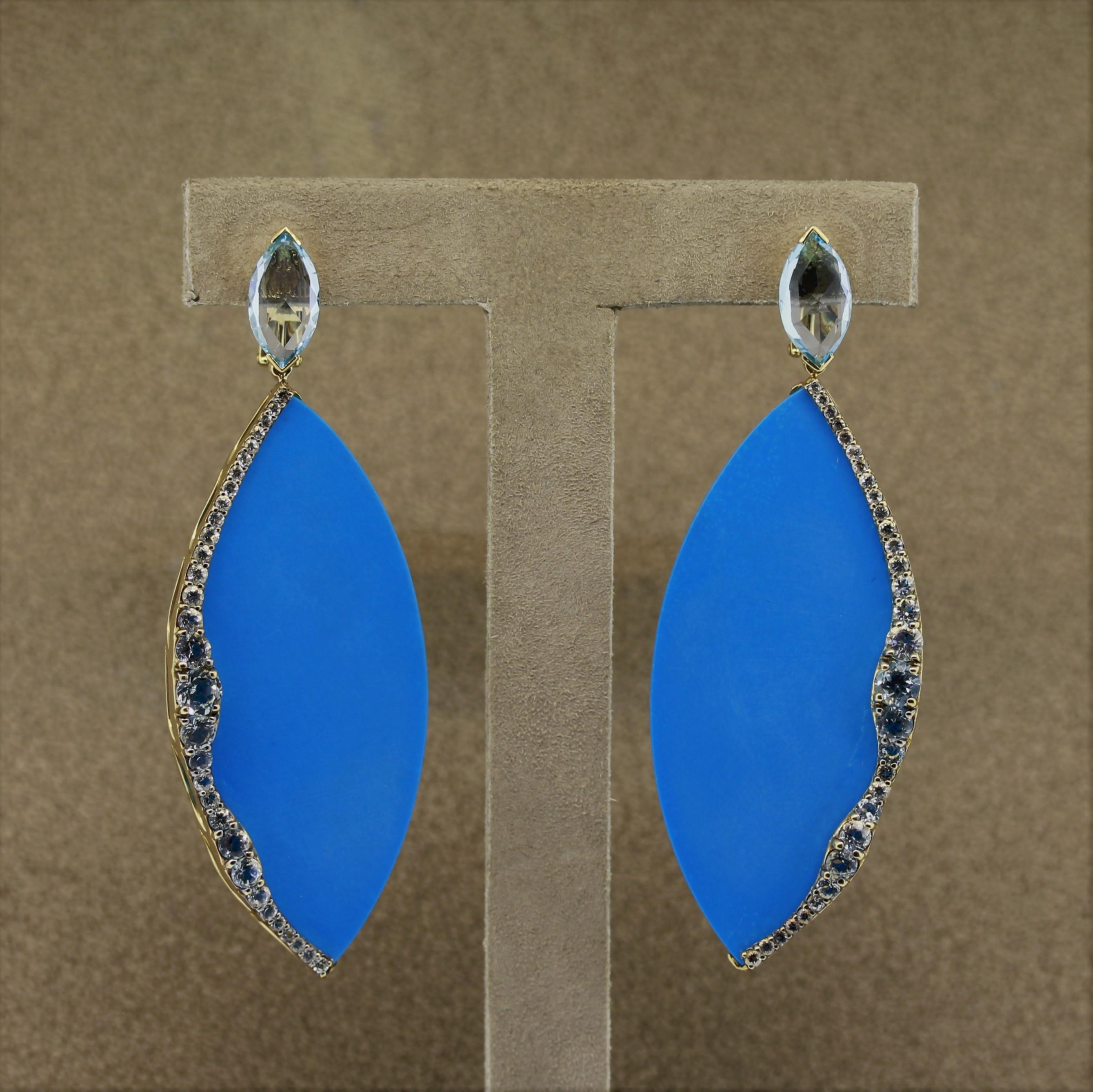 A fabulous pair of earrings made to evoke emotions of the sea and ocean. They feature two fine blue gemstones, a pair of marquise shaped turquoise and lovely ocean blue aquamarines. The aquamarine are set in the sides of the turquoise reminiscent of