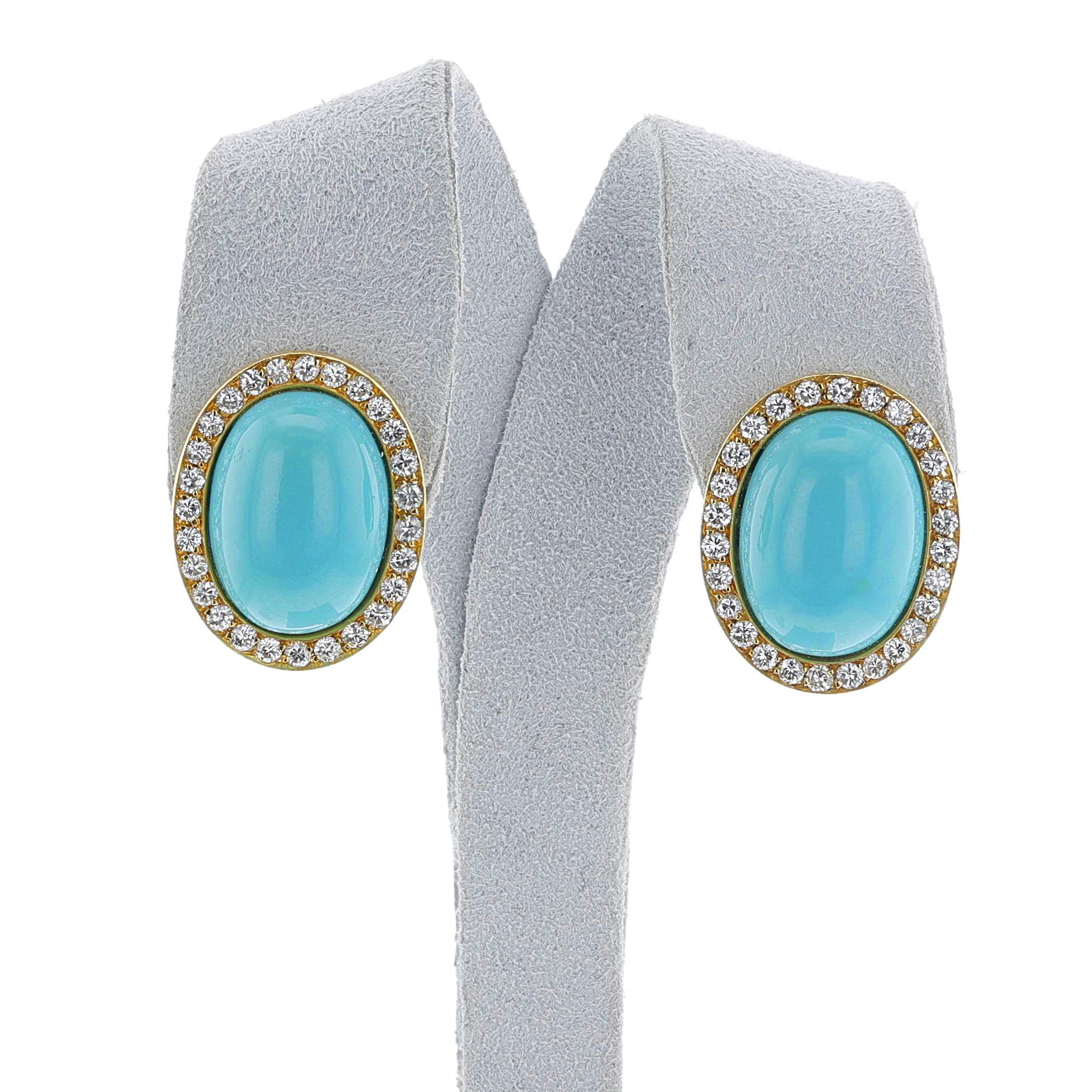 A pair of large natural turquoise cabochons surrounded by diamonds made in 18k yellow gold. The dimensions of the turquoise cabochons is 18 x 13 MM. The diamonds weigh appx. 1.07 carats. The total weight of the earrings is 15 grams. The dimensions