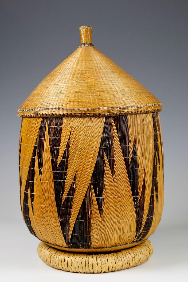 The distinctive sculptural form of this large Tutsi fibre basket from Rwanda - woven with the same double-layer 'igihisi' structure used to create Tutsi wall screens - is an expression of the Tutsi aesthetic. 

There is a beautiful sense of movement