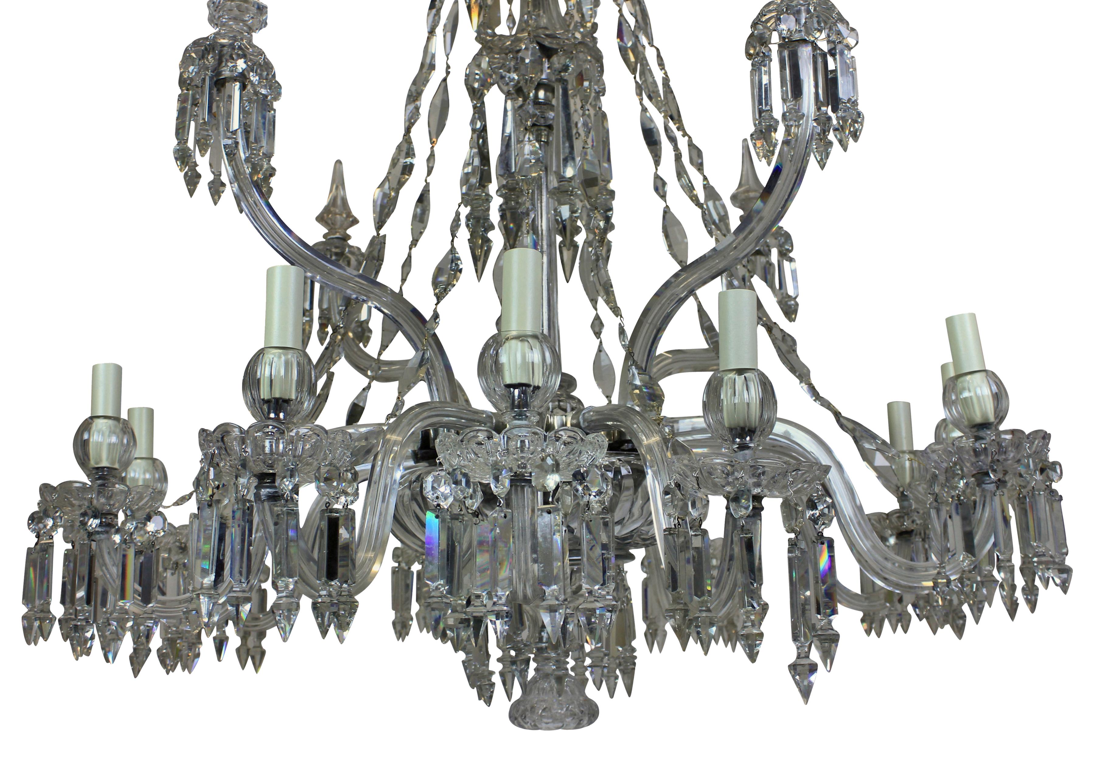 A fine English cut glass chandelier by F & C Osler. Formerly a gasolier and now electrified. With twelve arms hung throughout with finely cut diamond shaped chains and four large up-swept arms with spikes. The chains of diamond shape are a unique