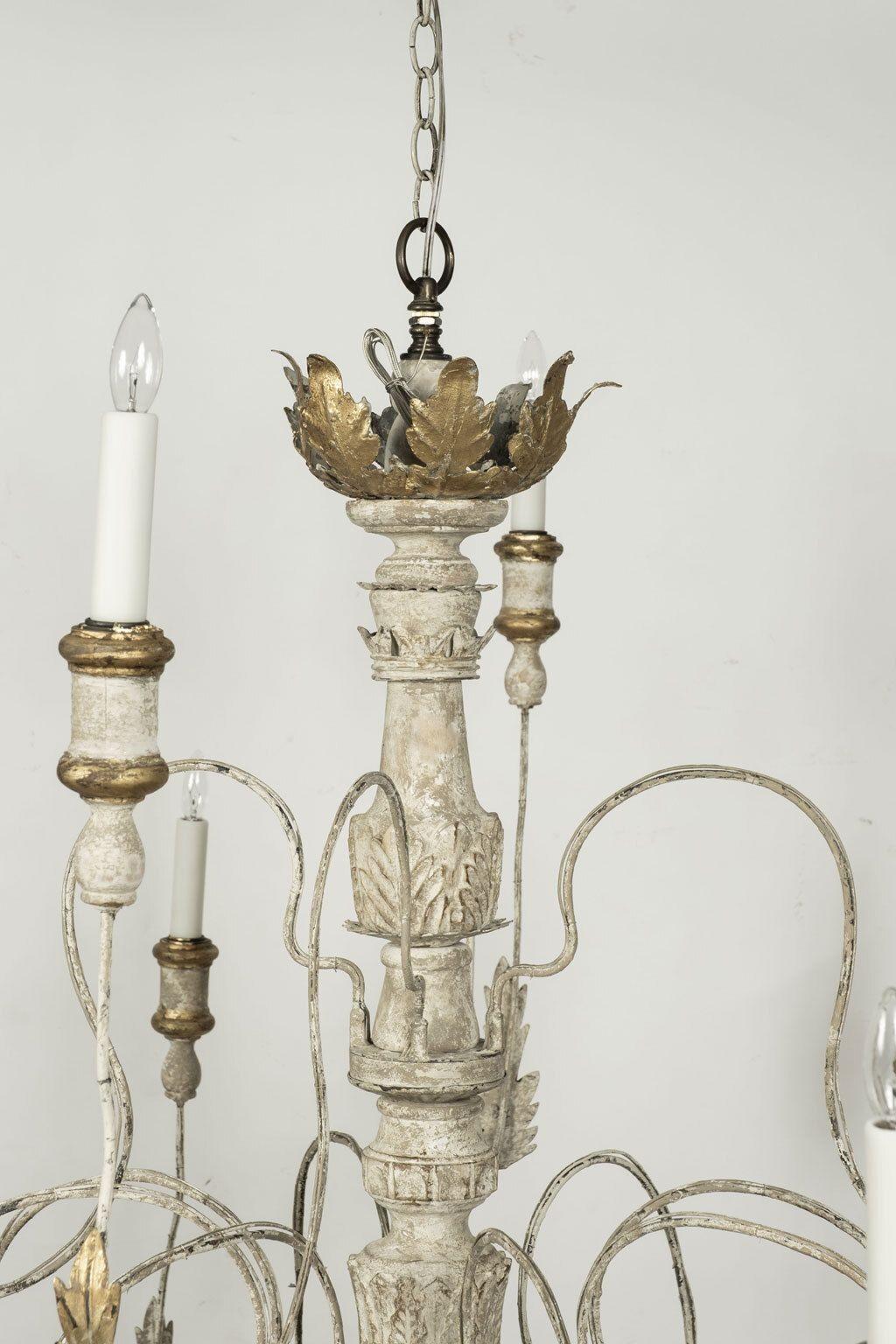 Large twelve-arm Italian chandelier, newly-constructed from 18th century and later elements. Chandelier is two tiers: lower tier has eight arms and upper tier has four arms. Gilded acanthus leave decoration adorns each arm. Newly wired, using UL
