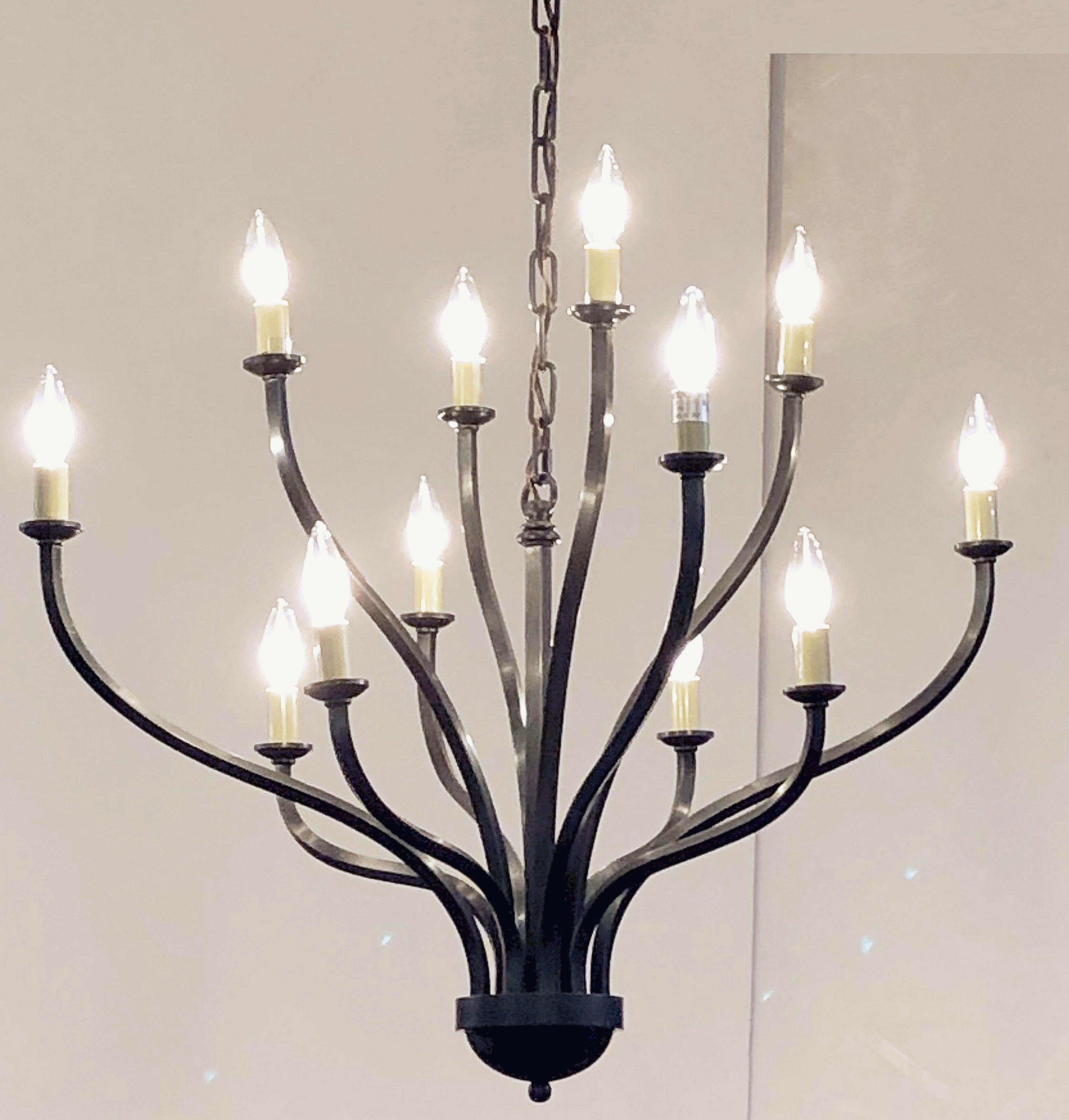 A large twelve-light hanging fixture of tubular metal, featuring a design of twelve ascendant arms around a column post.

U.S. wired, Ready for display.

Dimensions are approximately H 29 in x Diameter 32 in.