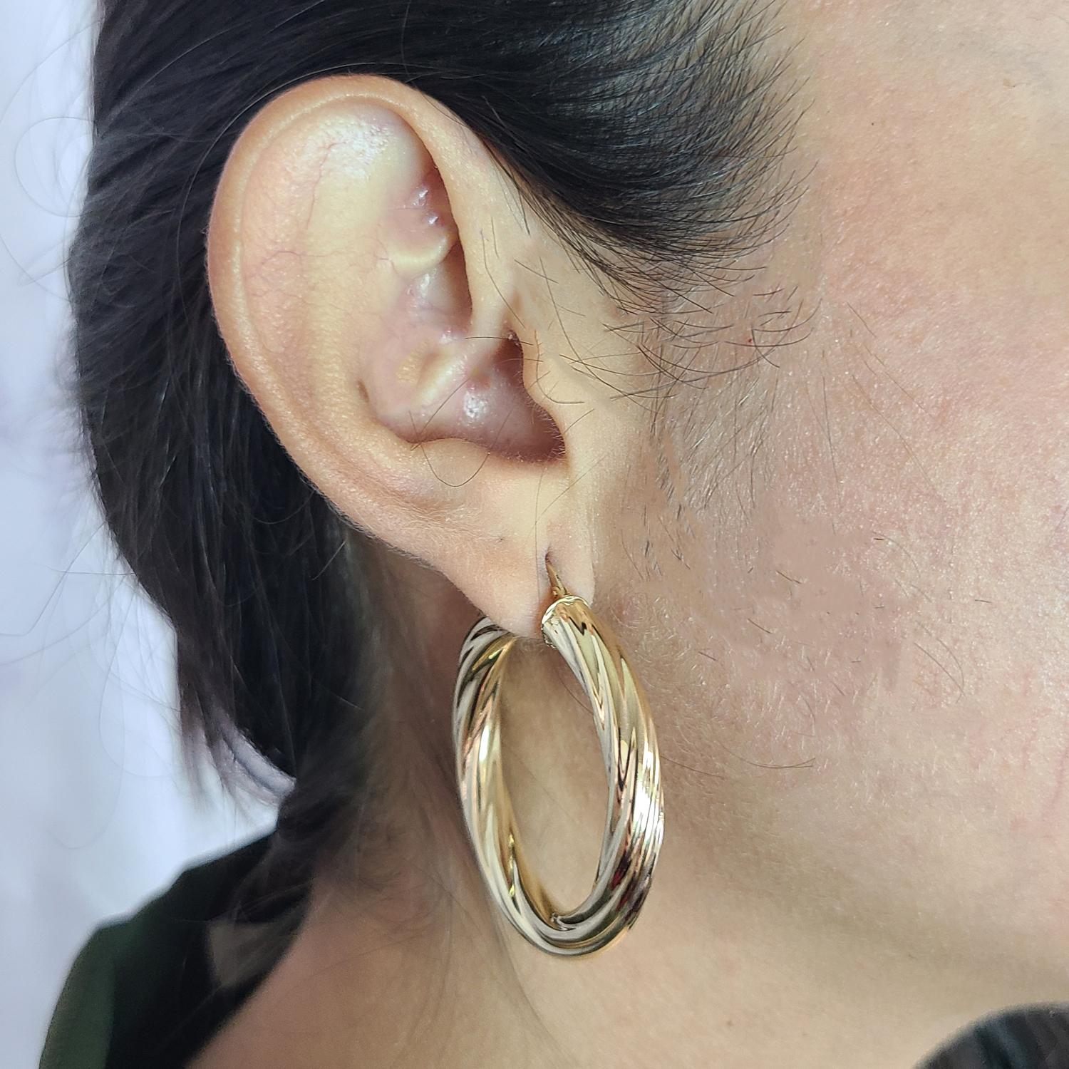 14 Karat Yellow Gold 6mm Wide Twisted Hoop Earrings with 1.75 Inch Diameter. Pierced Hinged Post with U Clip Closure. Finished Weight is 7.6 Grams.