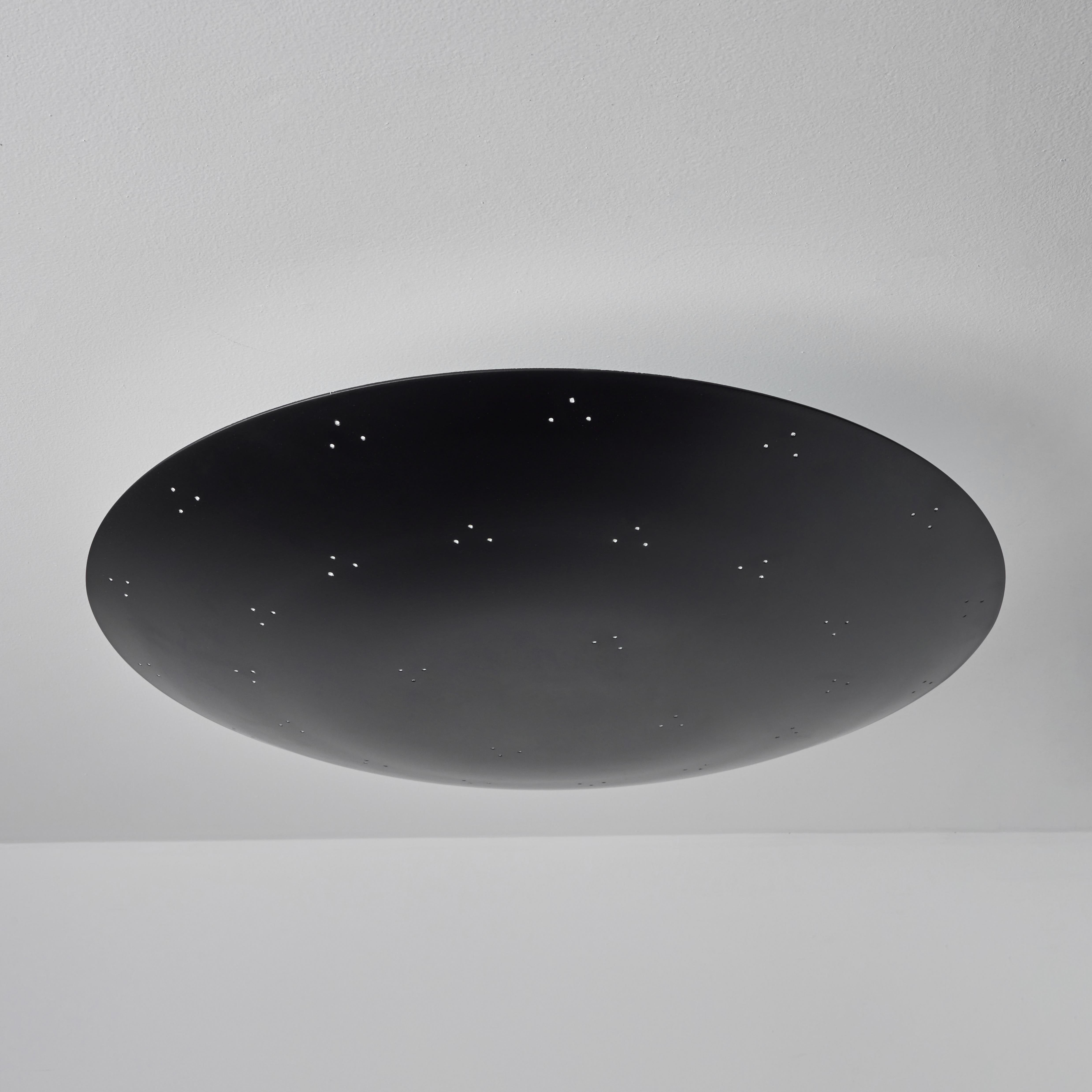 Large Two Enlighten 'Rey' perforated dome ceiling lamp in black. Hand-fabricated in Los Angeles, these highly refined ceiling lamps are reminiscent of the iconic mid-century Finnish designs of Paavo Tynell and Lisa Johansson Pape. Executed in black