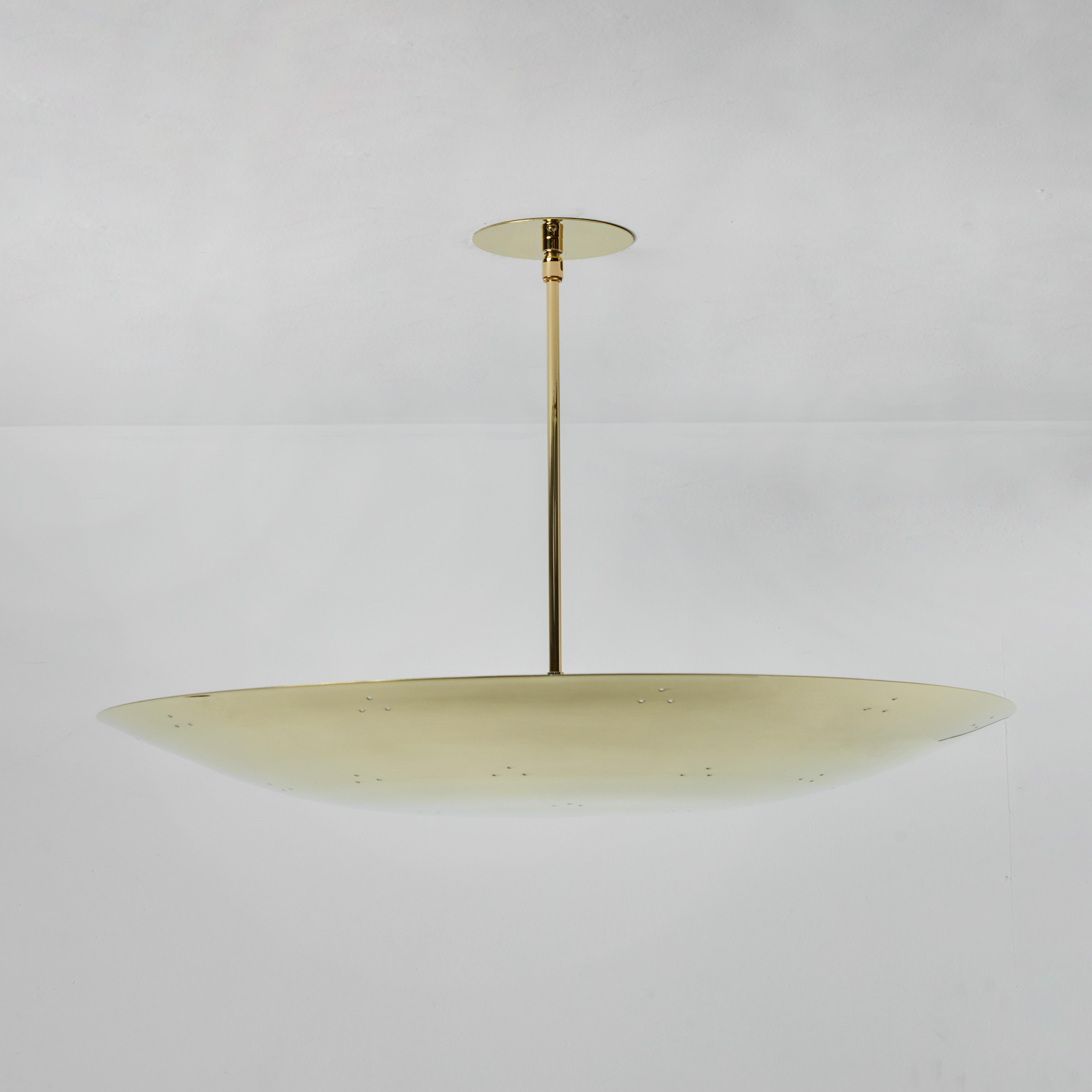 Large two enlighten 'rey' perforated polished brass dome chandelier. Hand-fabricated in Los Angeles, these highly refined ceiling lamps are reminiscent of the iconic midcentury Finnish designs of Paavo Tynell and Lisa Johansson Pape. Executed in