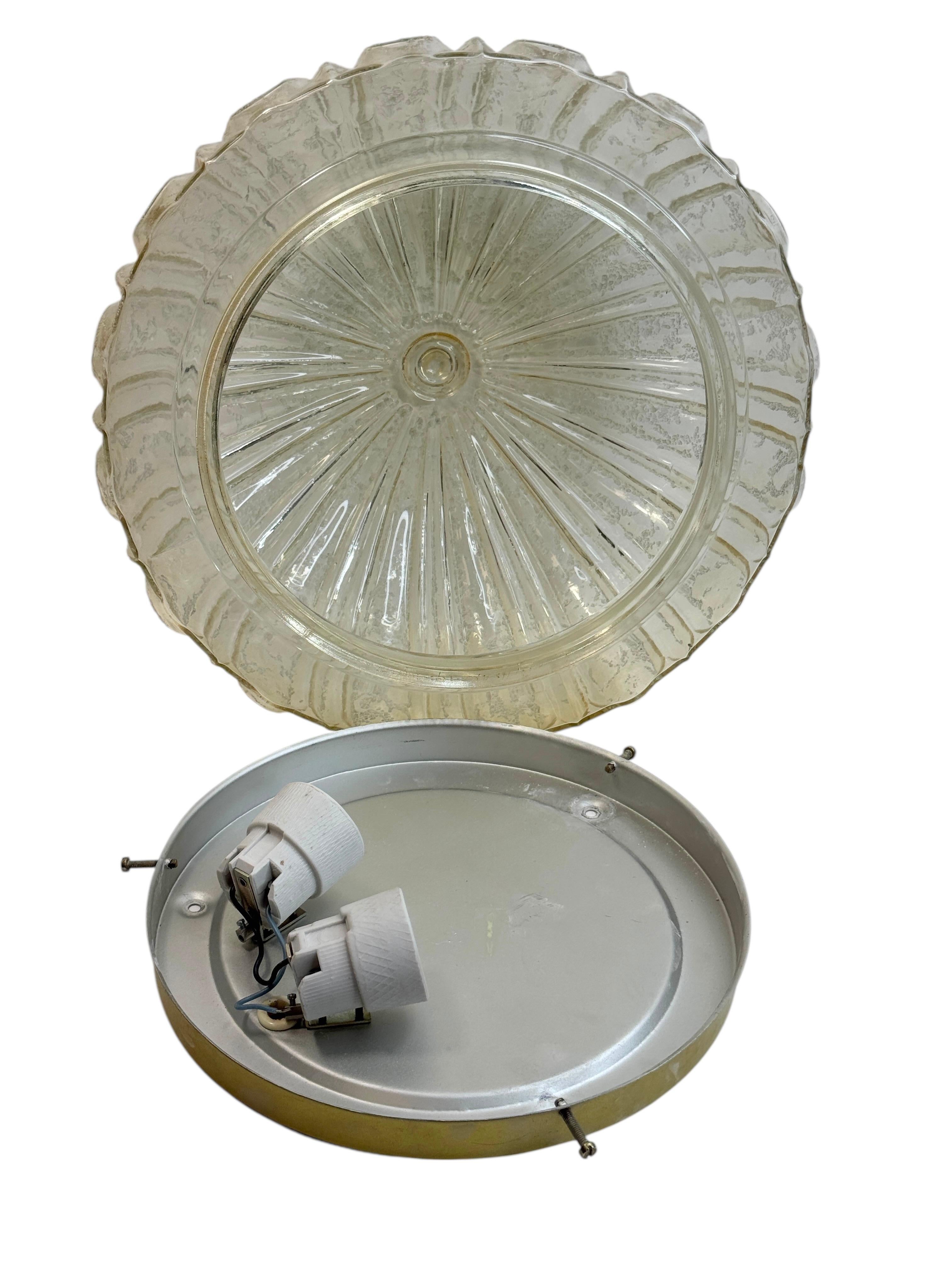 Beautiful organic glass flush mount. Made in Germany by Glashütte Limburg. Gorgeous textured light amber colored glass flush mount with metal fixture. The fixture requires two European E27 Edison or medium bulb up to 75 watts. A nice addition to any