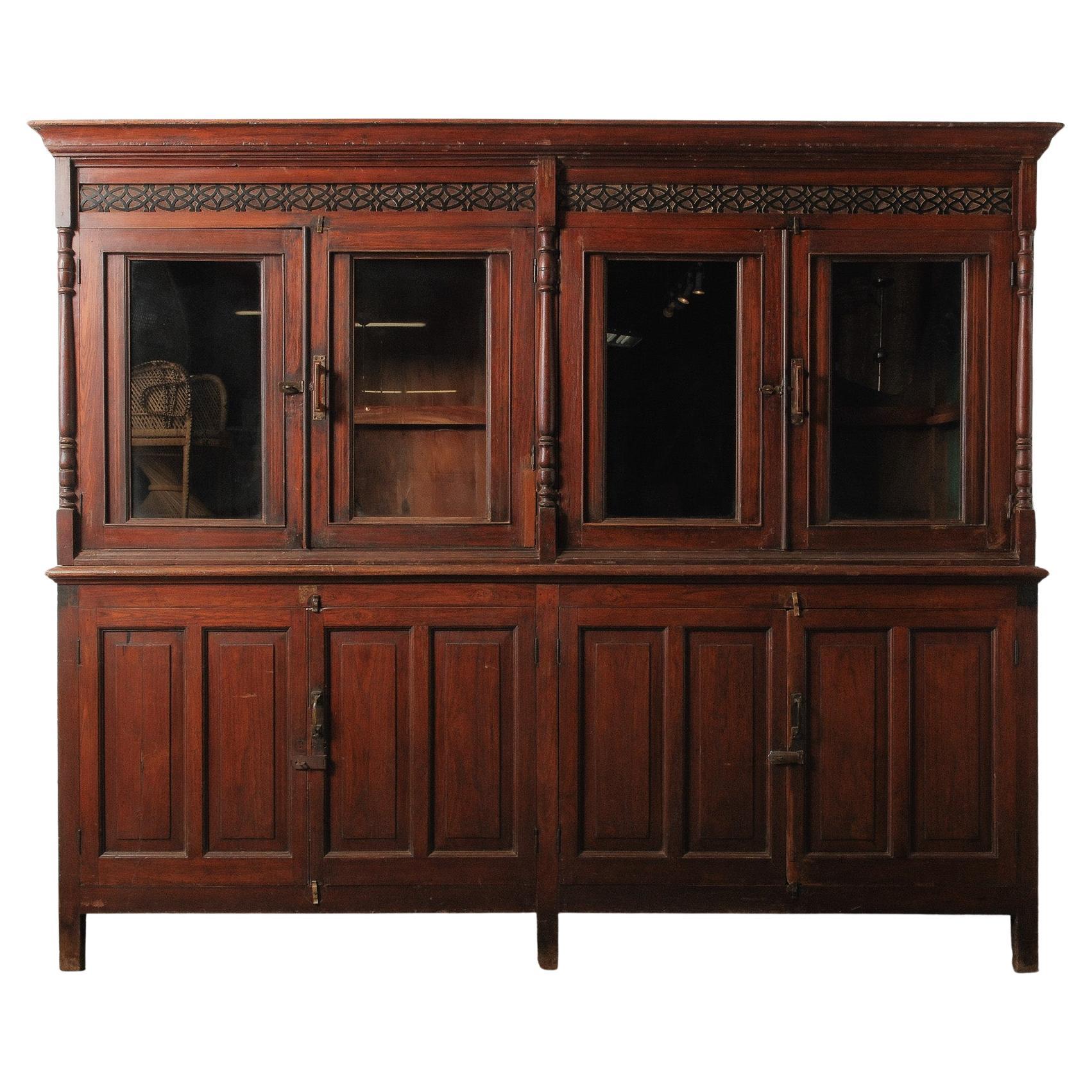 Large Two-Part Wooden Glass-Front Cabinet with Paneled Base and Carved Detail