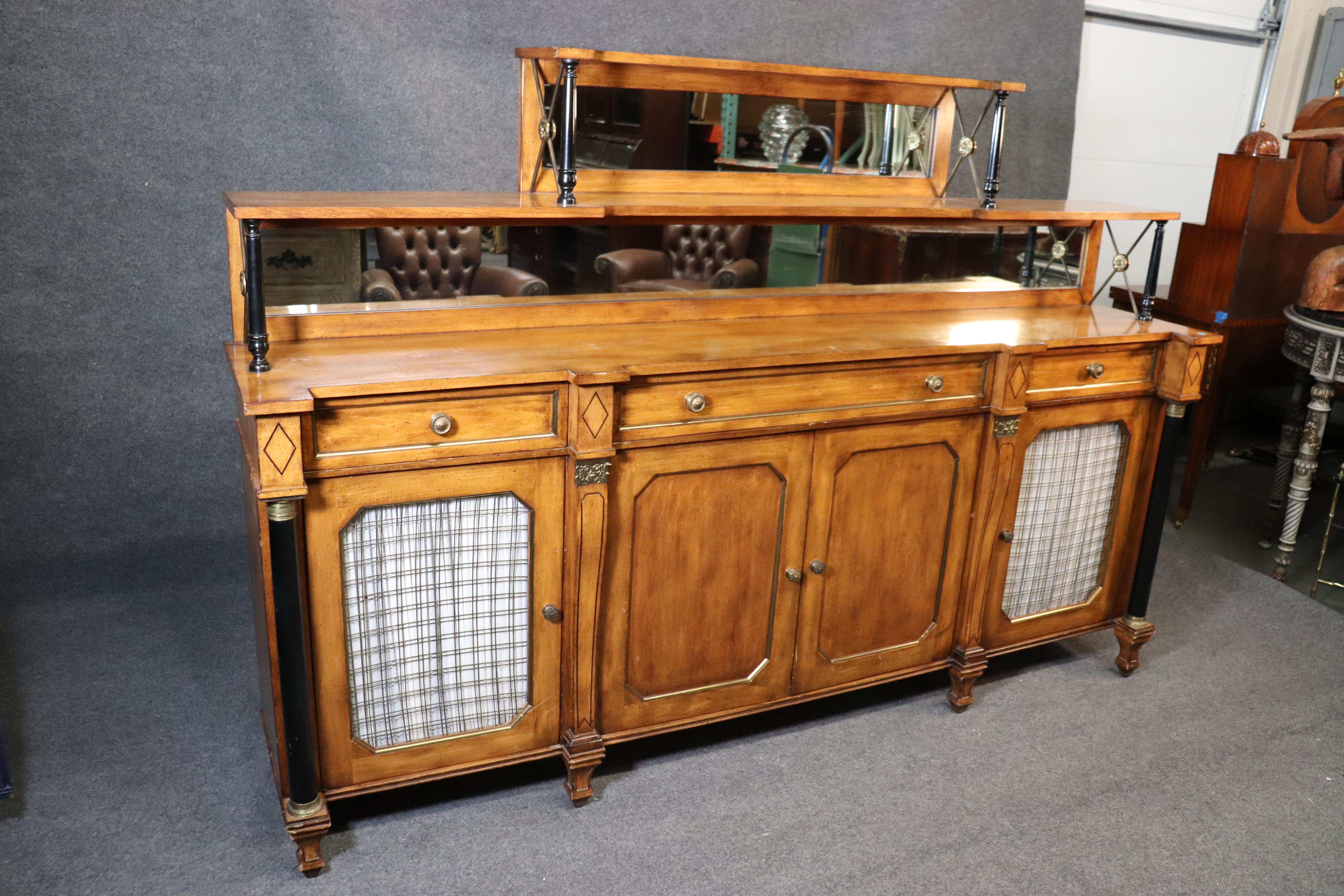 This is a grand French Regency style sideboard in good original condition with brass inlay and bronze ormolu. The sideboard measures: 84 wide x 57 tall x 17 deep and works well in tight shallow spaces. Dates to the 1950s era and looks like Maslow