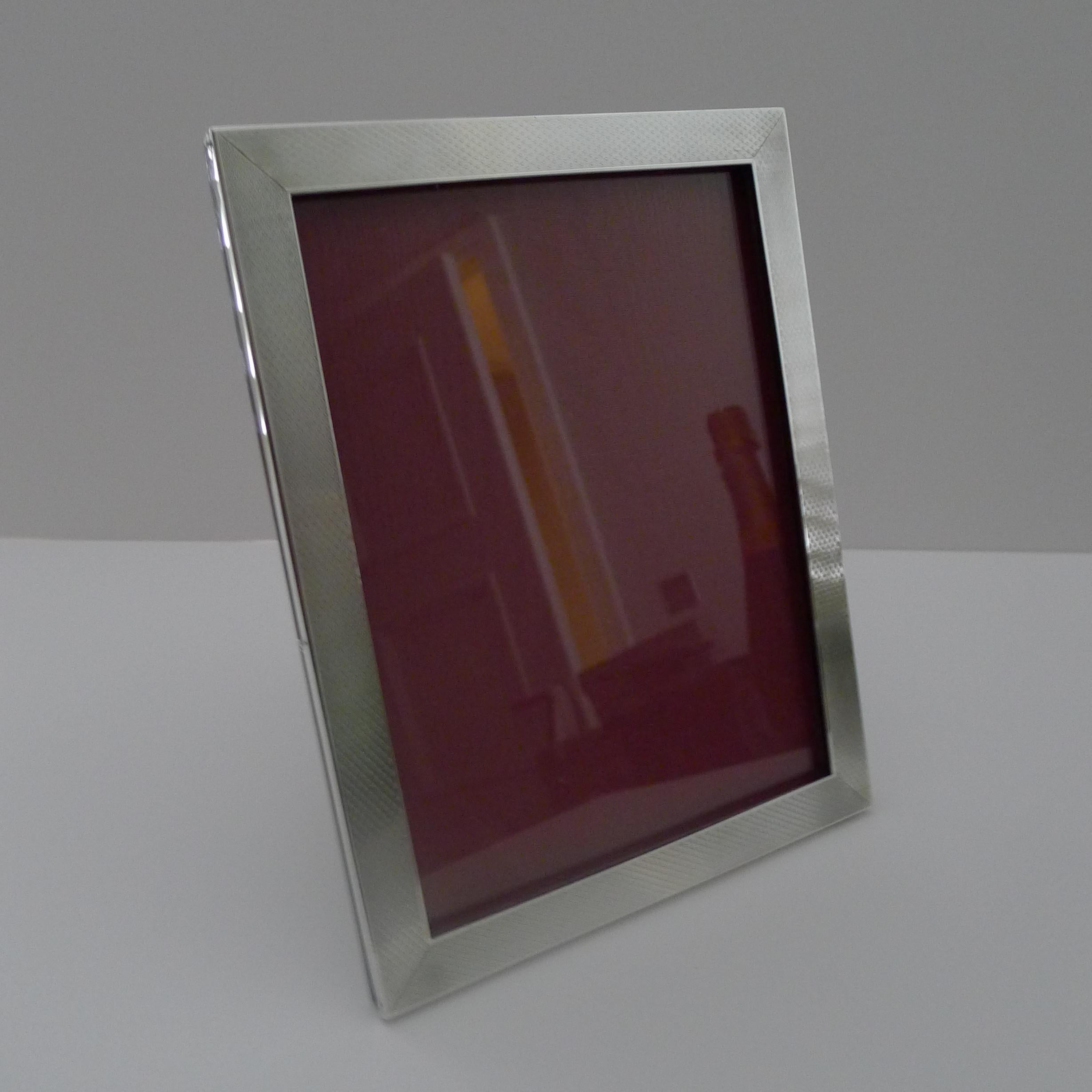 A smart and elegant photograph frame made from English solid silver backed with solid English Oak, incorporating a two-way folding easel stand; allowing for the frame to be used in both a landscape and portrait configuration.

The silver is