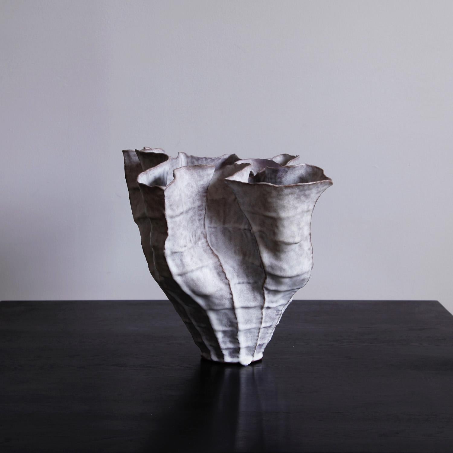 Young Mi Kim is a Korean ceramicist who works and teaches in Woodstock, New York. Young Mi’s pieces are painstakingly hand built. She layers strands of clay in a coil, slowly and carefully working upward as she discovers the shape. She writes, “In