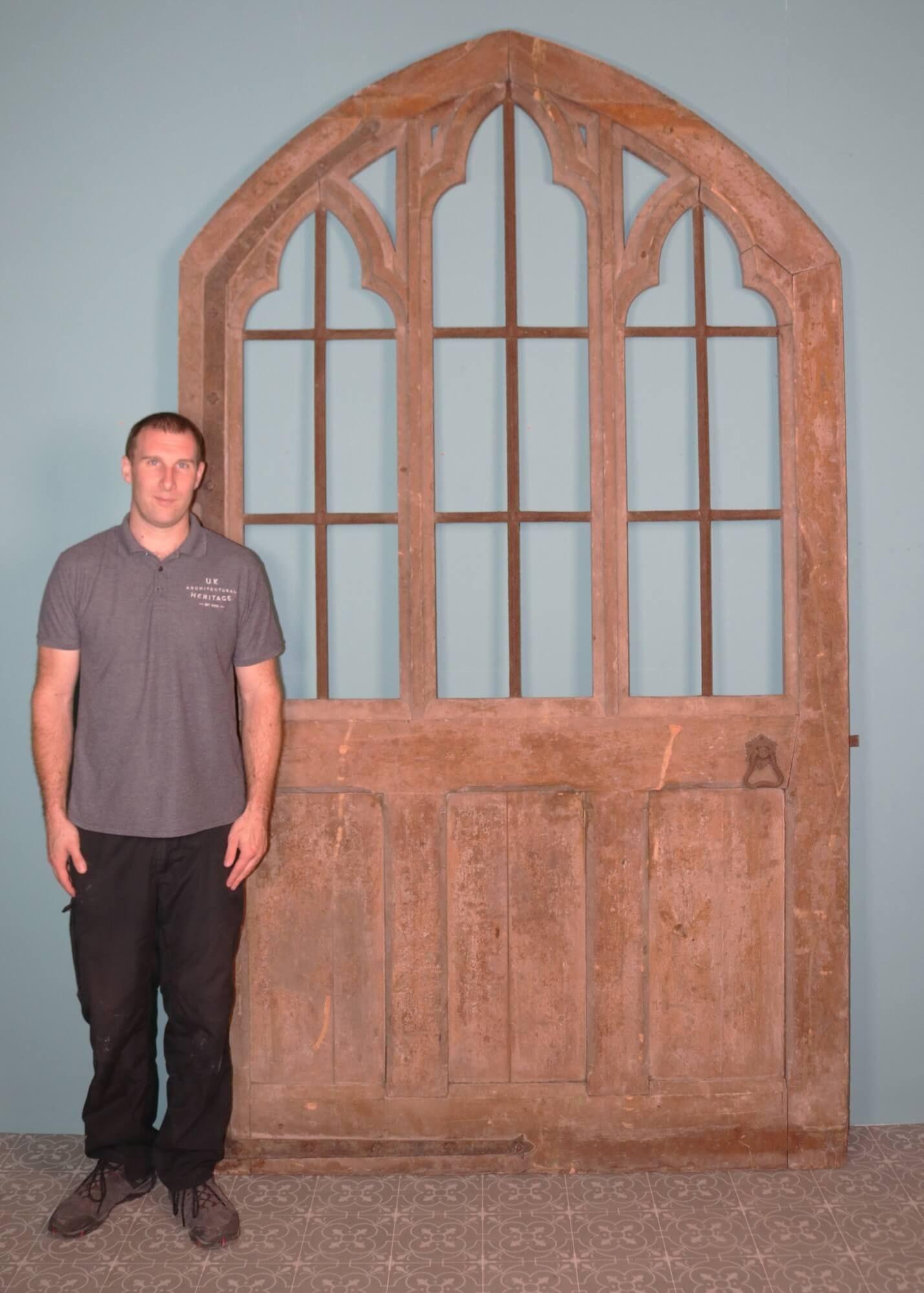 Standing at almost 3m tall, this huge unglazed antique gothic door dates from the early 19th century. Purportedly, it was taken from Rugby School in Warwickshire, a site with a rich history and architecture of the 18th and 19th centuries.