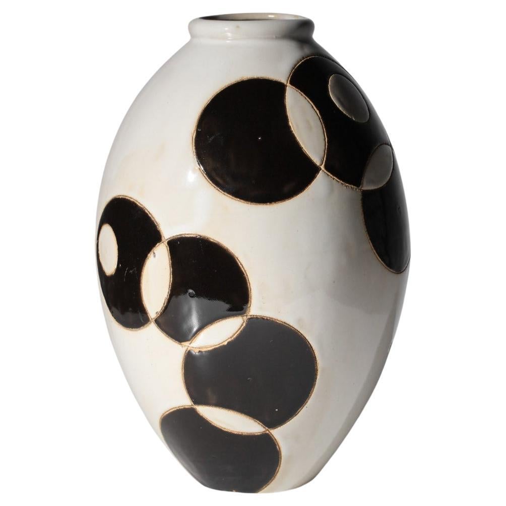 Large unidentified beige and black ovoid ceramic vase