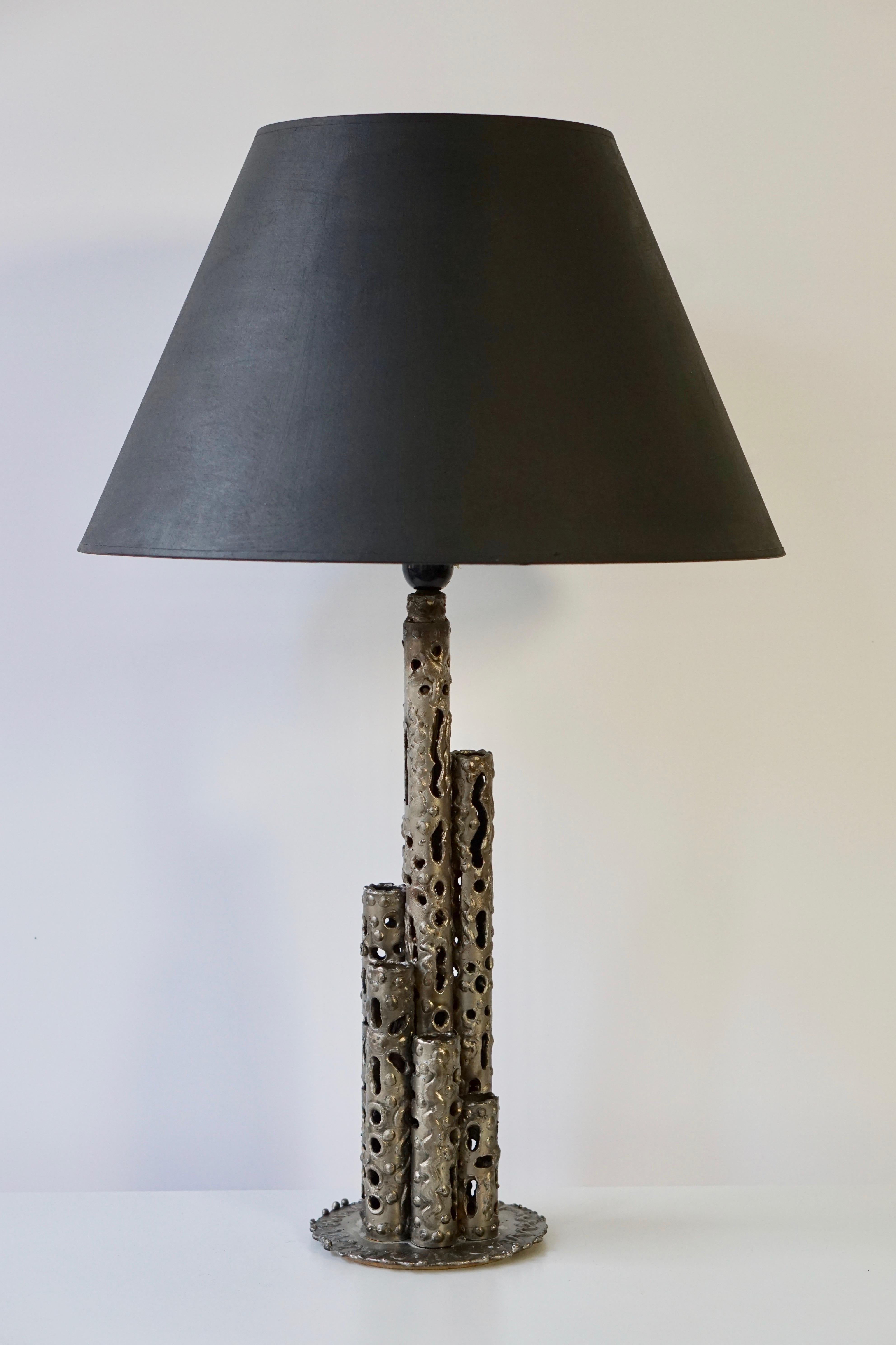 A pair of one-of-a-kind Brutalist style table lamps made of metal with great patina by Marcello Fantoni, manufactured in Italy in midcentury, circa 1970 (end of 1960s or early 1970s). 
A massive and very impressive craftsmanship. Unqiue and handmade