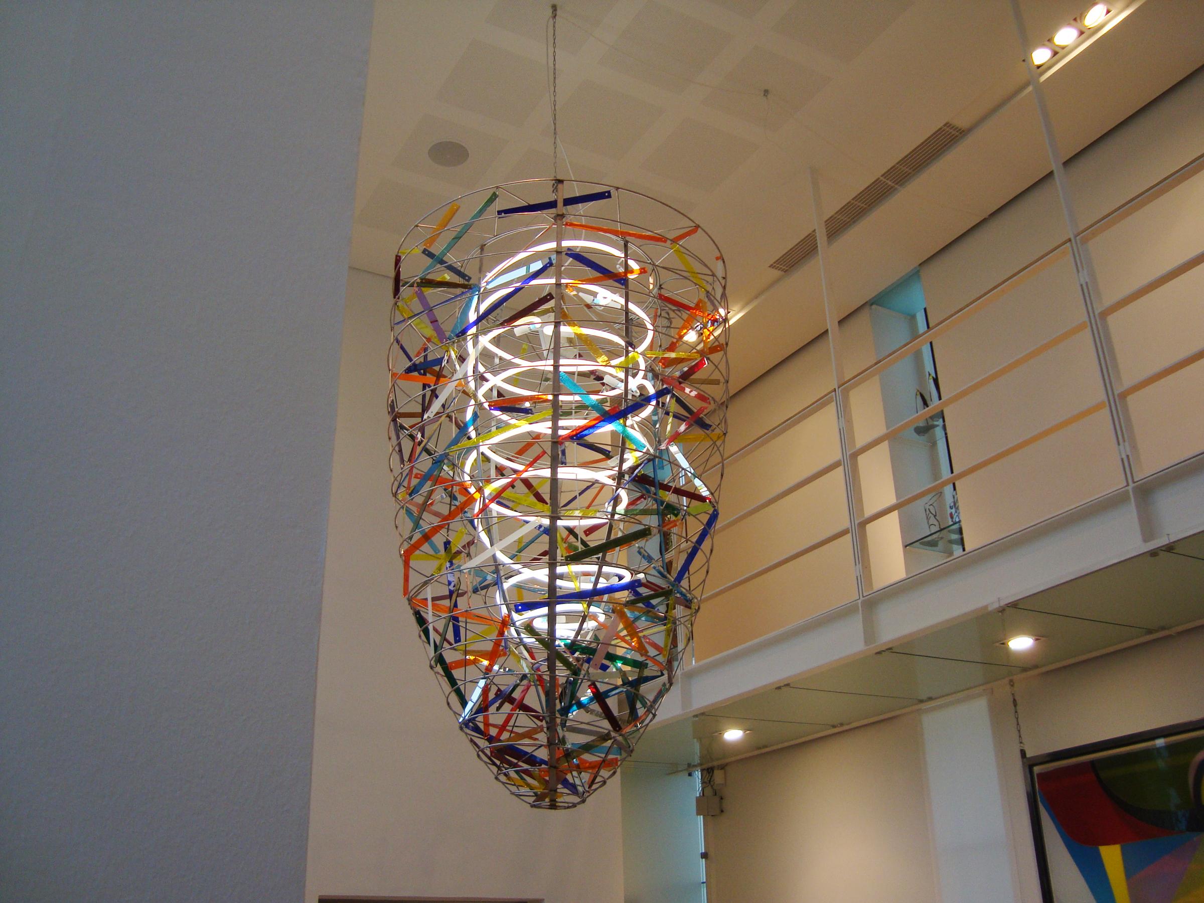 Very large unique handmade chandelier in stained glass and steel designed by the Danish artist Peter Stuhr.
This unique handmade chandelier can be delivered with different light sources. The pictures shows it with a custom made fluorescent tube. It