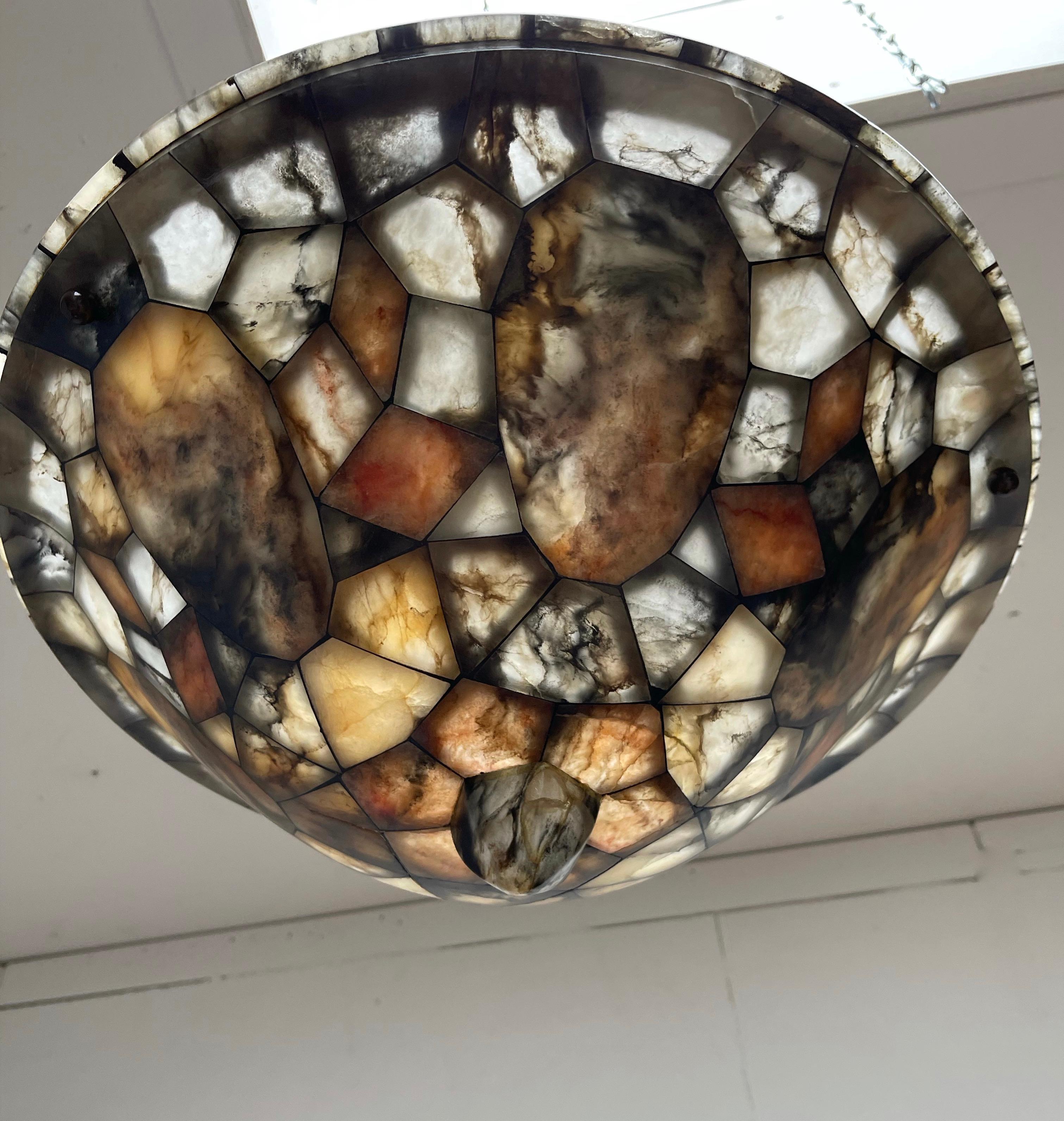 This amazing and impressive 1920s pendant is unlike anything you ever saw.

With early 20th century light fixtures as one of our specialities, over the years, we have sold a number of remarkable alabaster pendants. However, when we recently saw this