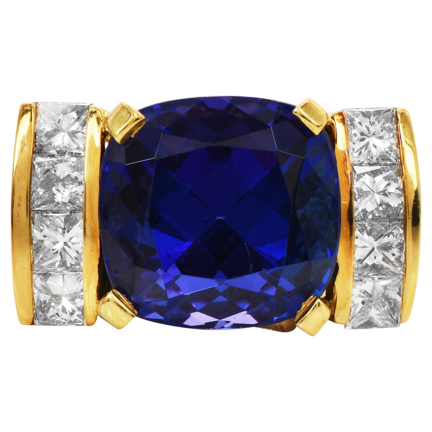 This statement ring is crafted in 18K Yellow Gold, the gold setting provides a warm and luxurious backdrop for the gemstones.

The centerpiece of the ring is a captivating approx. 18.00cts Square Cushion cut Genuine Tanzanite gemstone. Tanzanite is