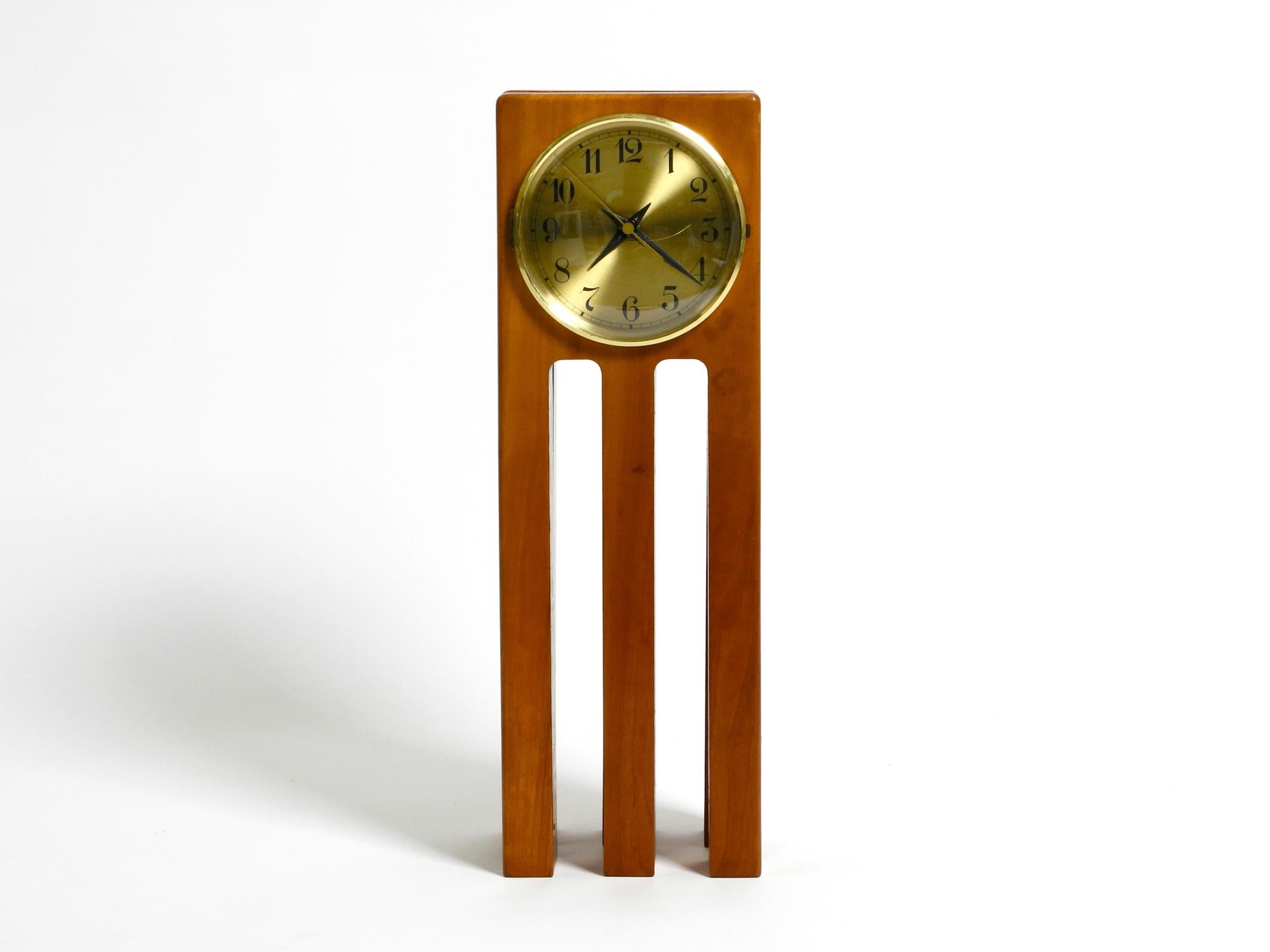 Large, unusual 1980s Postmodern design table clock made of cherry wood
Great interesting design made of solid wood. Manufacturer is unknown.
But it is certainly from a well-known manufacturer, because of the good quality.
With battery operation