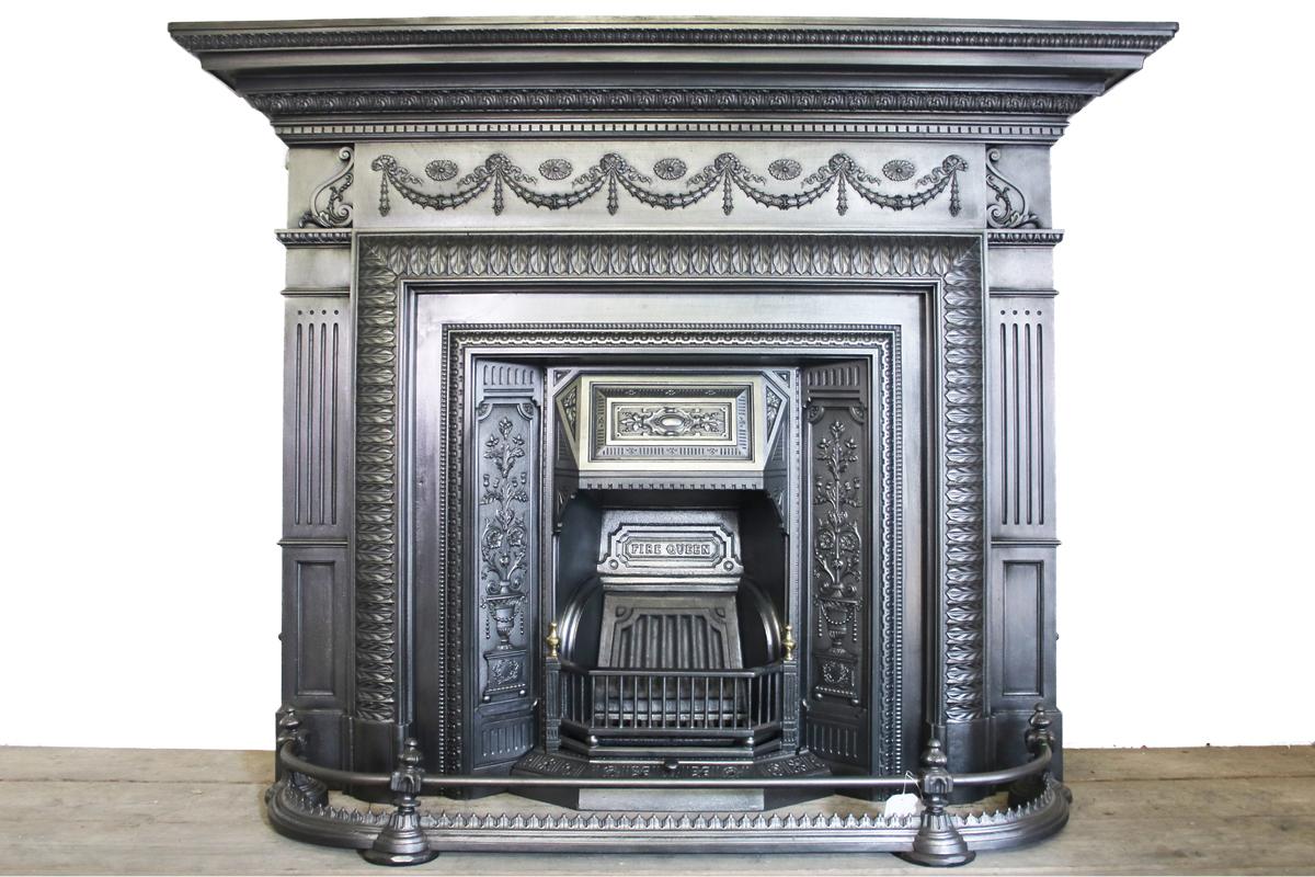 Large antique late Victorian cast iron fire surround festoons of flowers and rosettes to the frieze and an unusual convex frame decorated with fine acanthus leaves, circa 1890. 

Pictured with an original cast iron grate and fender, available but