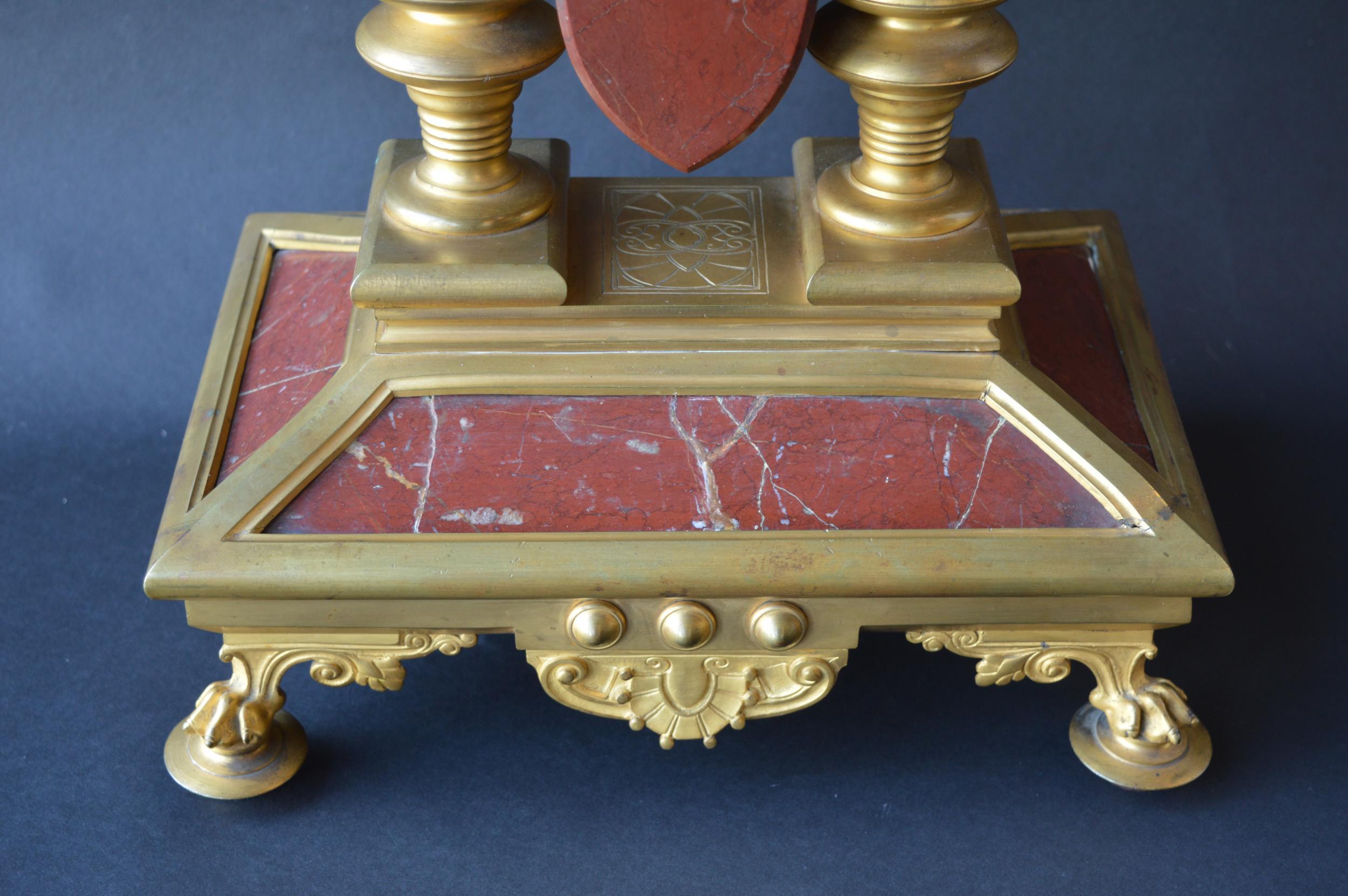 Large unusual French Neo-Grec Revival gilt bronze mounted marble mantel (fireplace) clock, circa 1870. The shaped rouge griotte marble arched case centering a circular dial with gilt Roman chapters and steel Breguet hands above twin key escapements,
