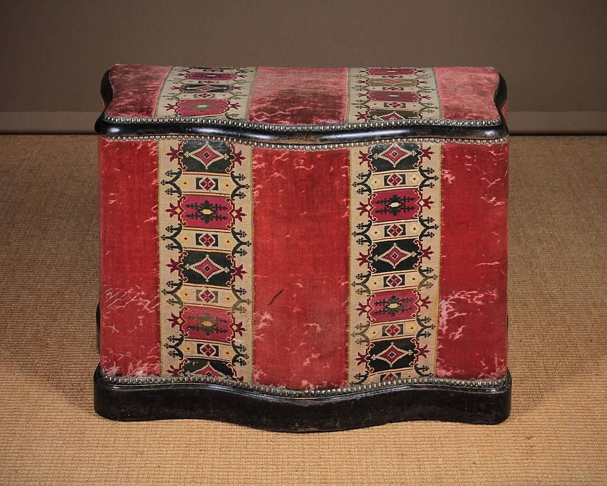 A rare and attractive box seat of good proportions being three feet wide and taller than normal at 27 inches. Having its original upholstery of scarlet velvet with bold woven tapestry pattern panels. The padded seat top opens to reveal a useful