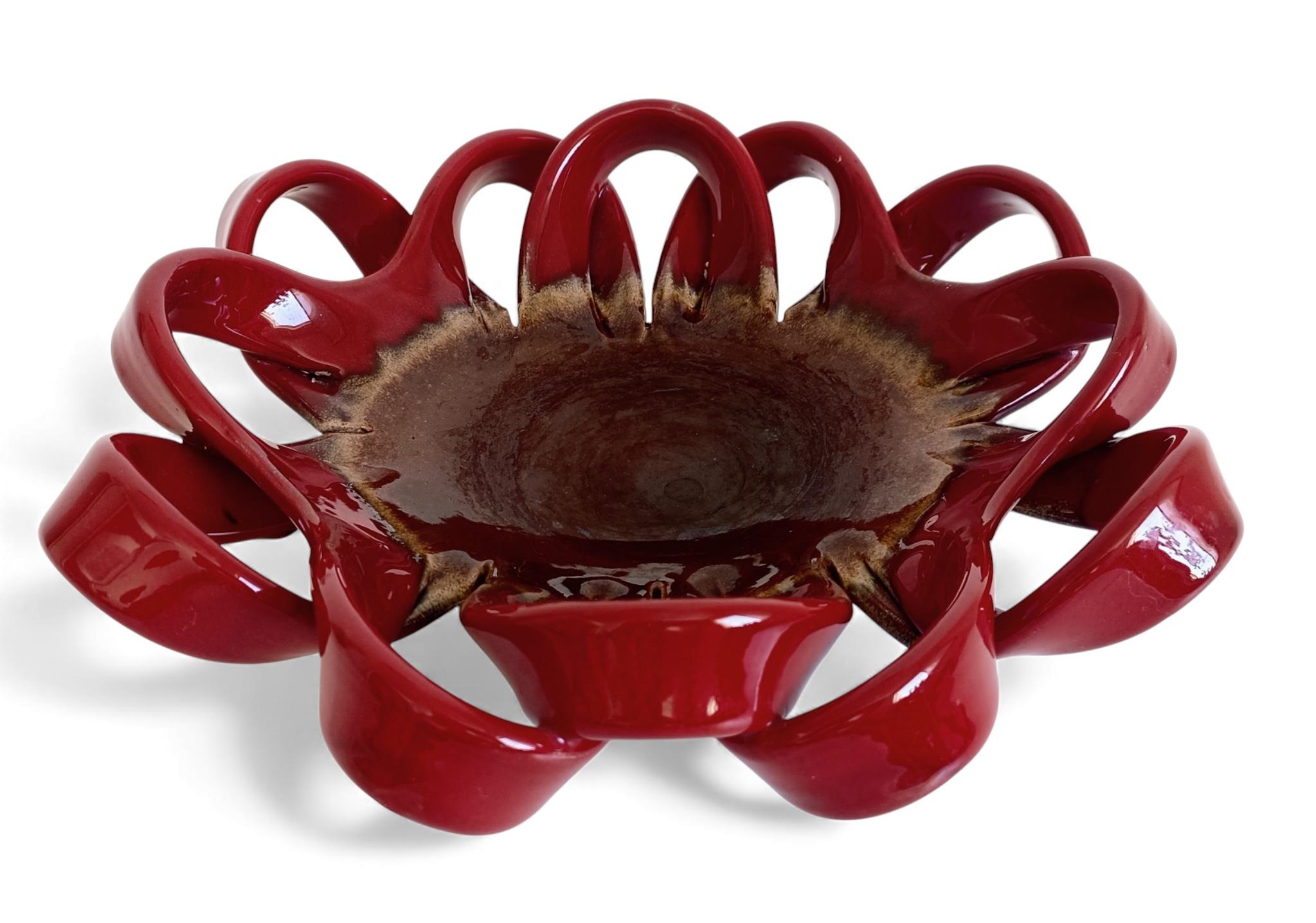 Large Vallauris Hand-Made Faience Ceramic Centerpiece, France, 1950s

An absolutely stunning large ceramic fruit bowl or centerpiece, featuring an intricate sculptural body in rich oxblood faience, artfully woven around a central bowl in earthy