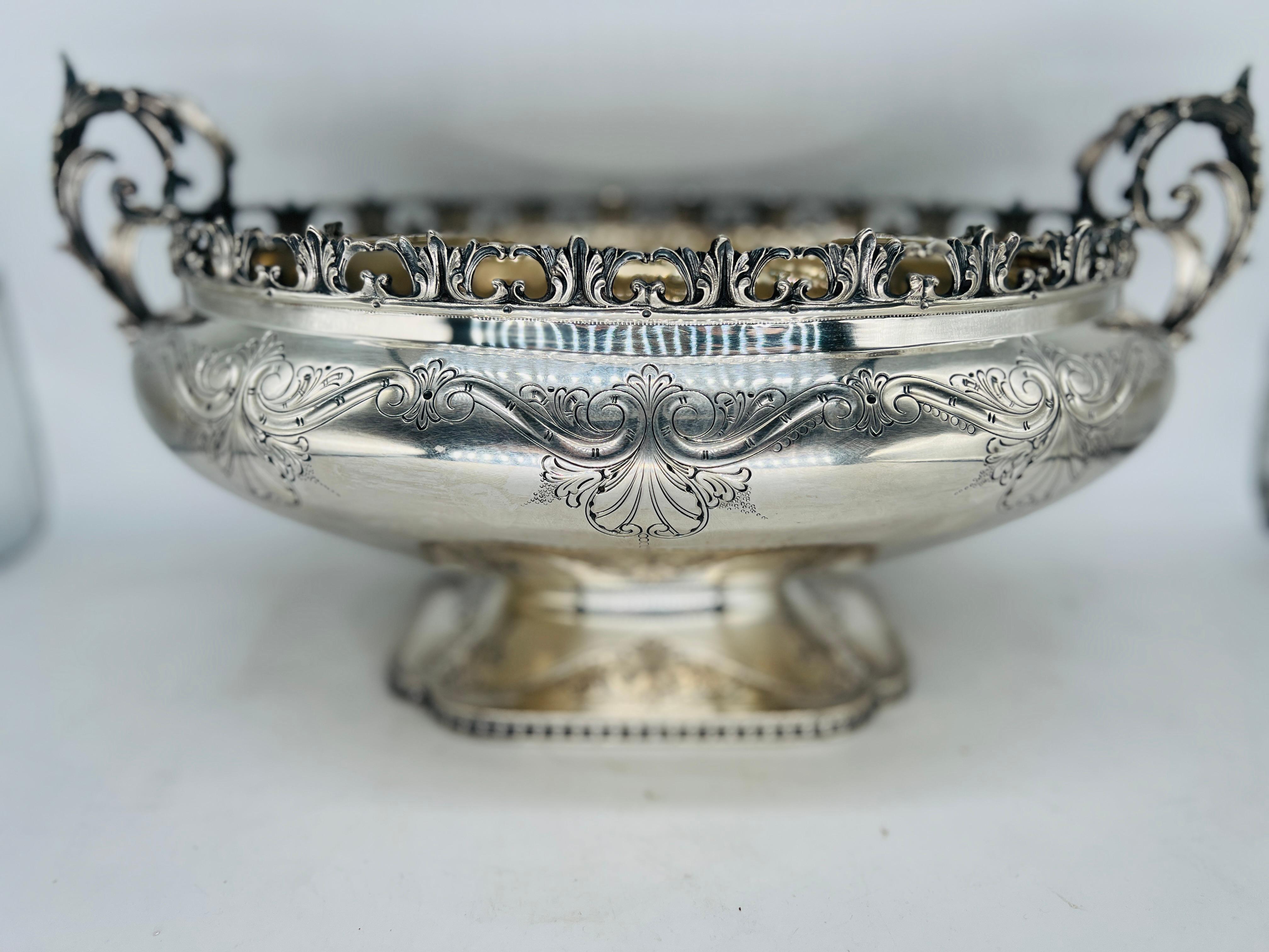 This large Valle' & Gandini 800 sterling silver Rococo centerpiece exemplifies the Italian Rococo style with extraordinary attention to detail and elegance. The pierced rim enhances its decorative appeal, allowing light to flow through and