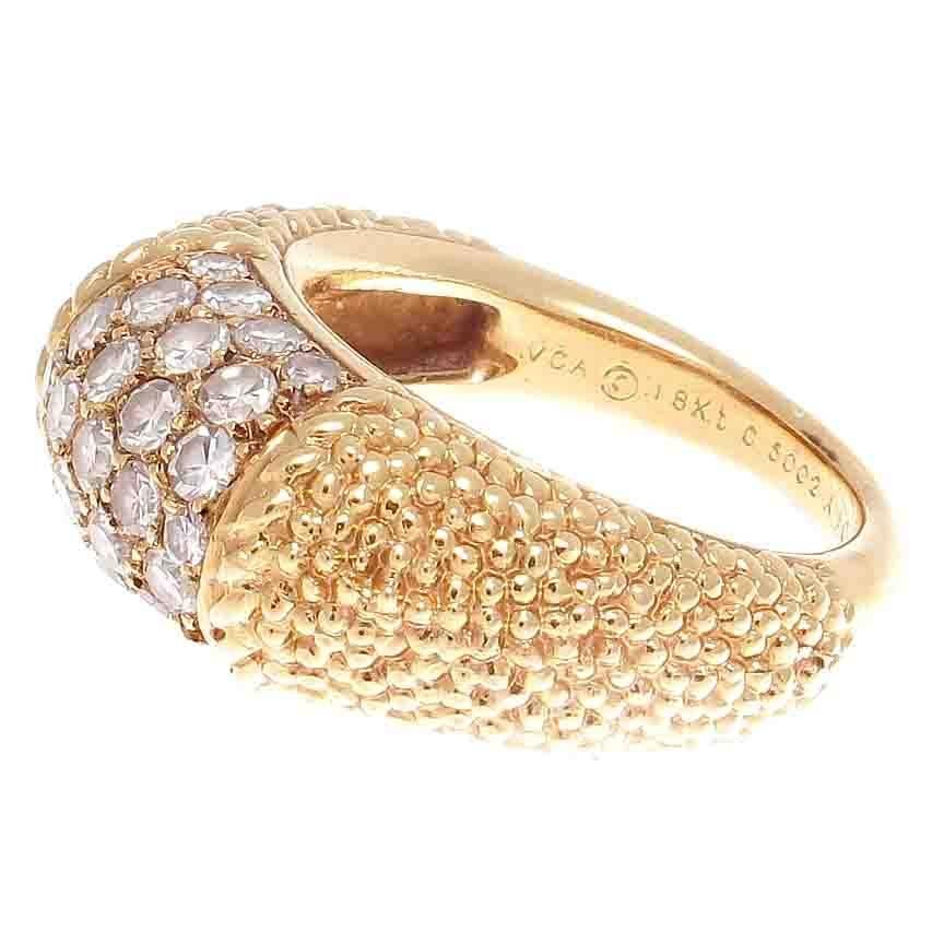 The singular a la mode Philippine collection from Van Cleef & Arpels.  Featuring numerous colorless diamonds accentuated by shoulders of textured 18k gold. Signed VCA, numbered and stamped with french hallmarks.

Ring size 6-1/2 and may be resized