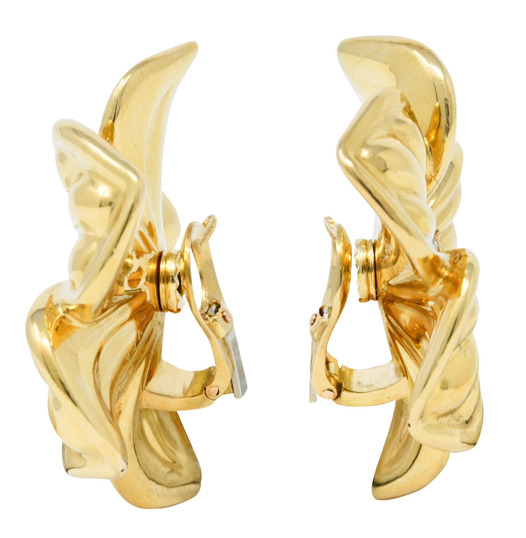 Ear-Clips are designed as stylized magnolia flowers with five deeply ridged petals

Centering round brilliant cut diamond clusters weighing in total approximately 0.85 carat - G/H color with VS clarity

Completed by hinged omega backs

Stamped 750