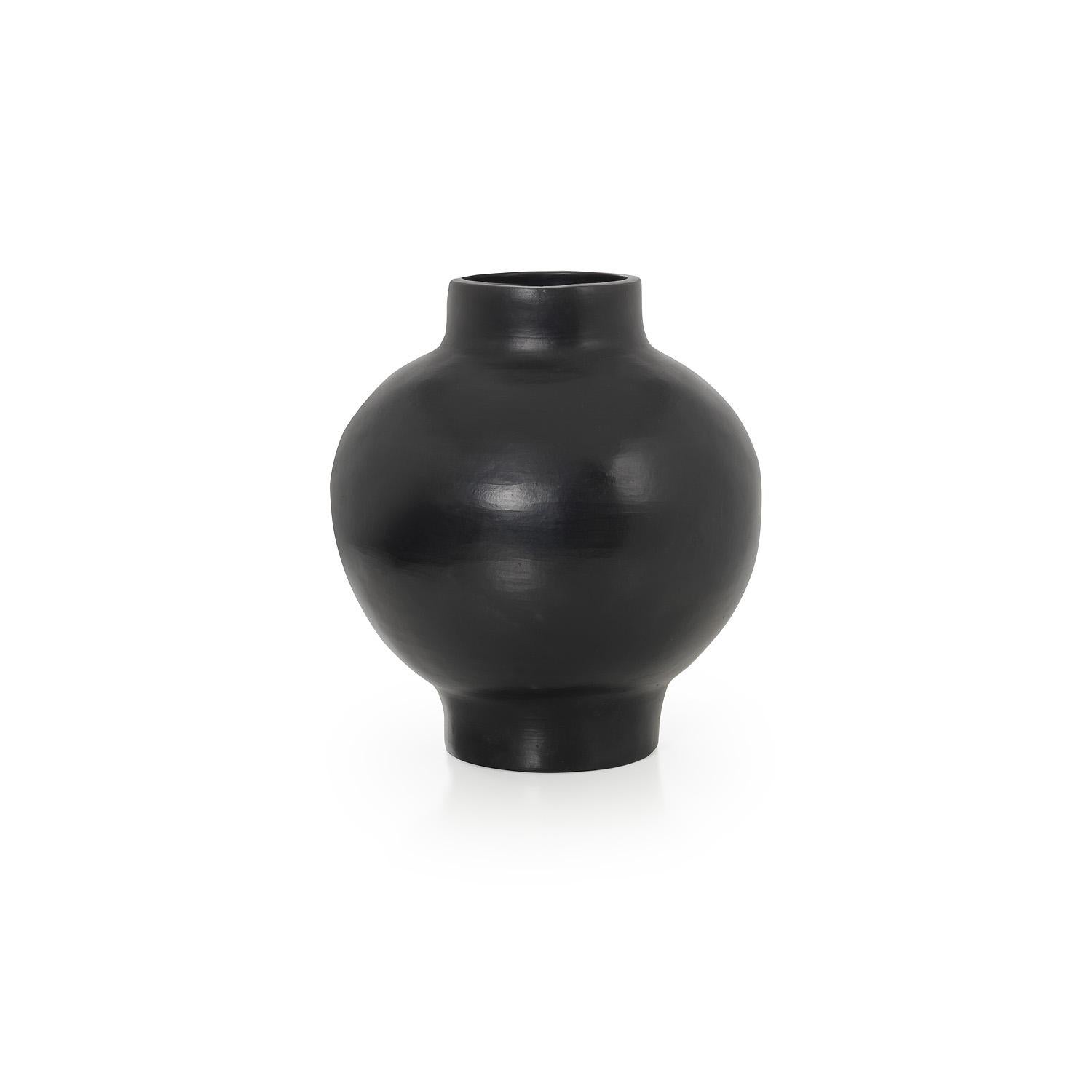 Large vase by Sebastian Herkner
Materials: Heat-resistant black ceramic. 
Technique: Glazed. Oven cooked and polished with semi-precious stones. 
Dimensions: Diameter 31 cm x H 34 cm 
Available in sizes small and mini.

This pot belongs to the
