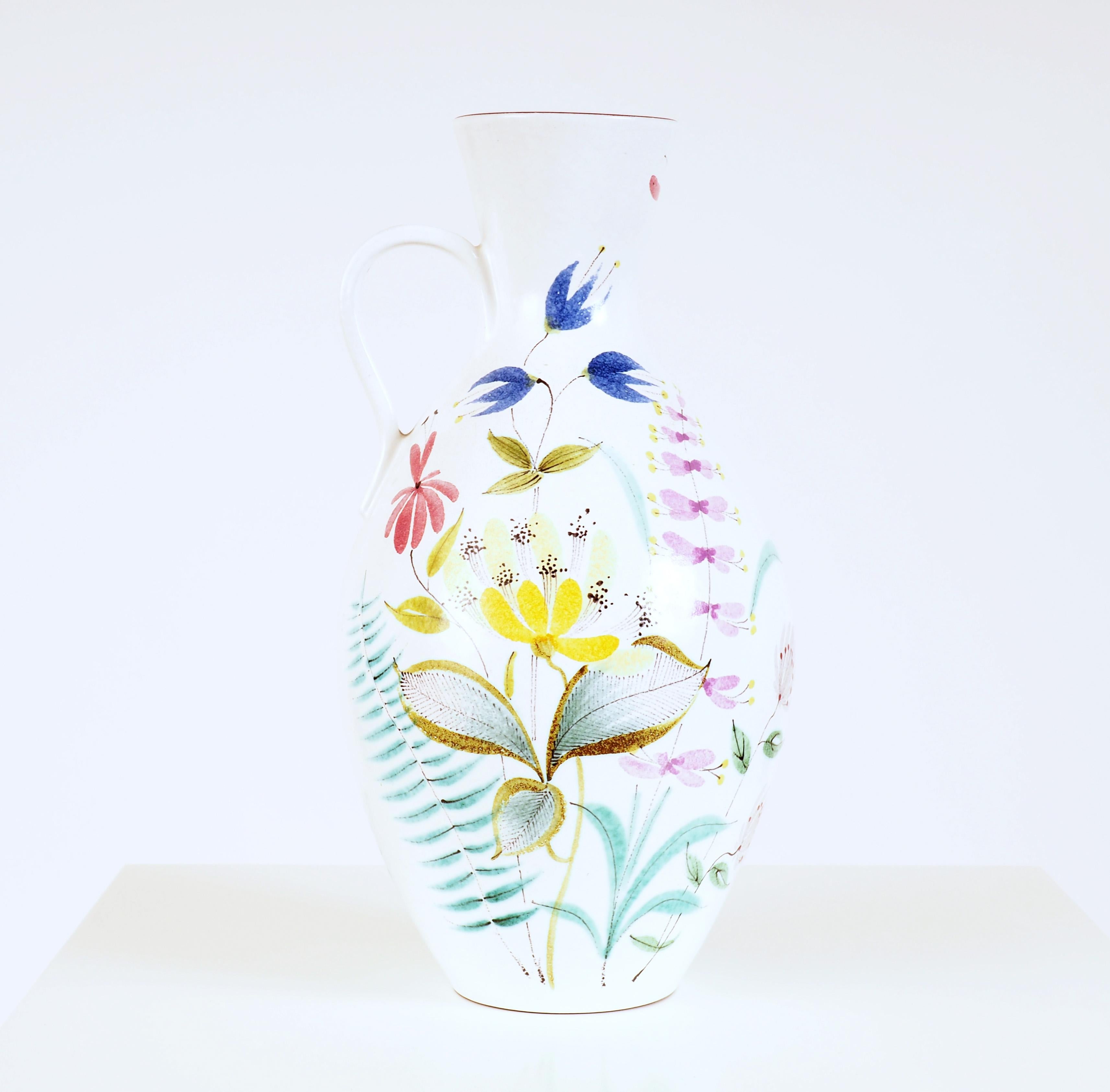 Large vase in hand painted faience by Stig Lindberg for Gustavsberg Studio. Lindberg began painting in the old faience technique in the early 1940s together with Wilhelm Kåge. This piece is typical for his early flower decorations.