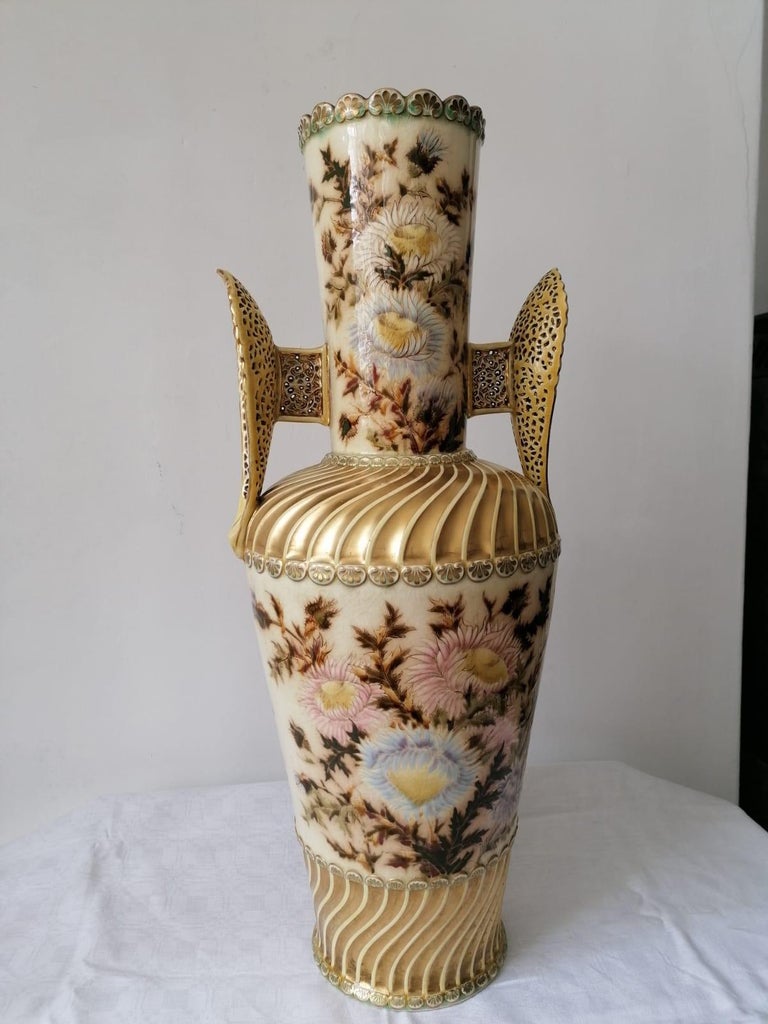 Porcelain faience, partially double-walled openwork, floral decoration painted in color and gold, height 67cm, mark with MEK, gold edge somewhat rubbed. Made in Hungary by Zsolnay, circa 1880.