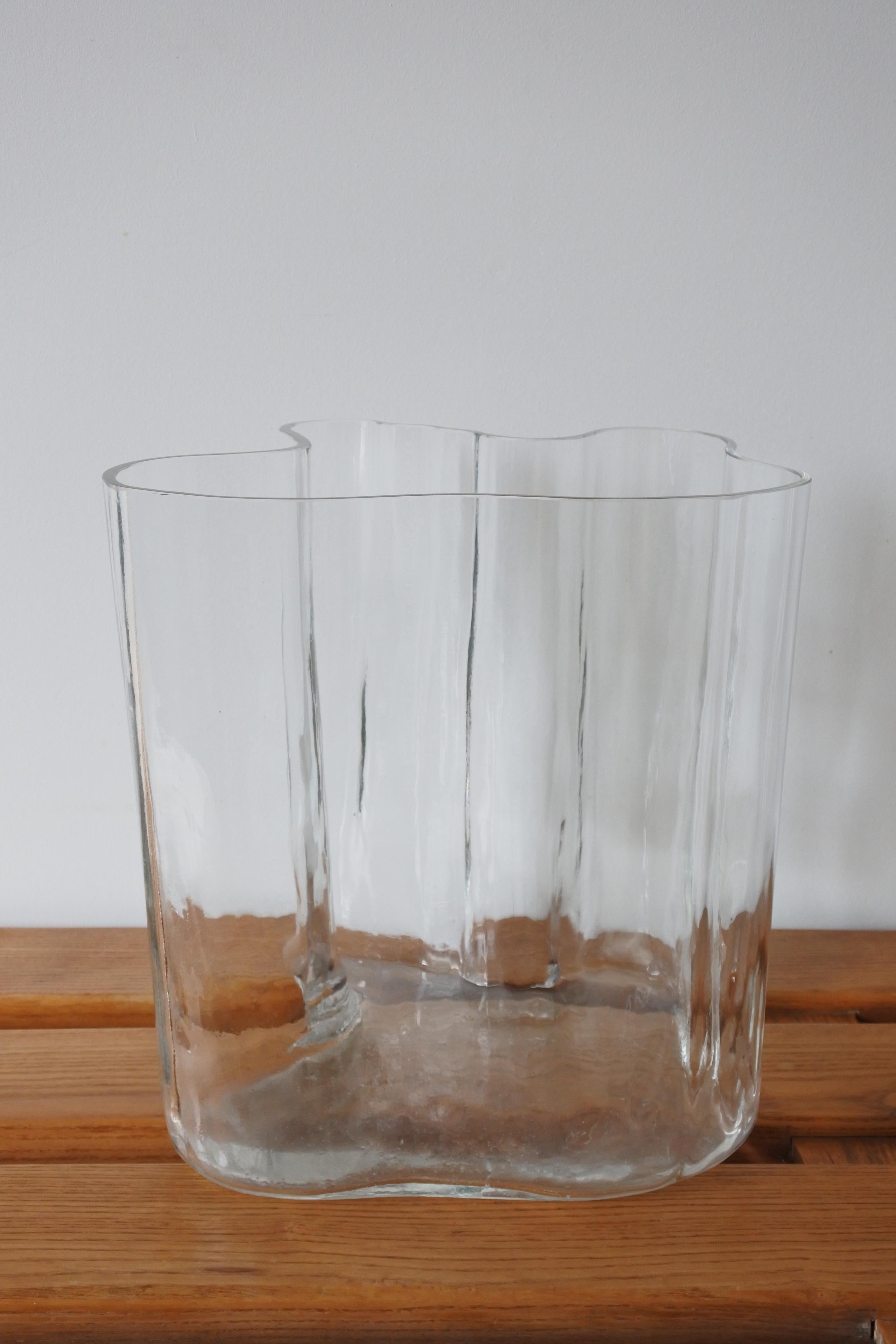 Clear glass vase by Alvar Aalto, model 3031 also known as Savoy vase
Made by Iittala in 1956
Still-blown into a wooden mould.
Engraved 