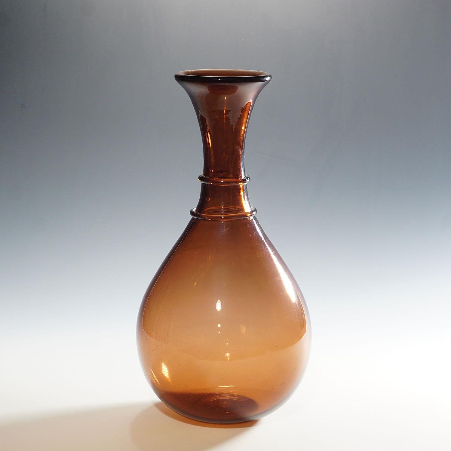 A large vase in thick amethyst glass with circular decoration on the neck. Designed by Paolo Venini in 1952, manufactured by Venini, Murano Venezia. Model number 1522. Acid stamp 