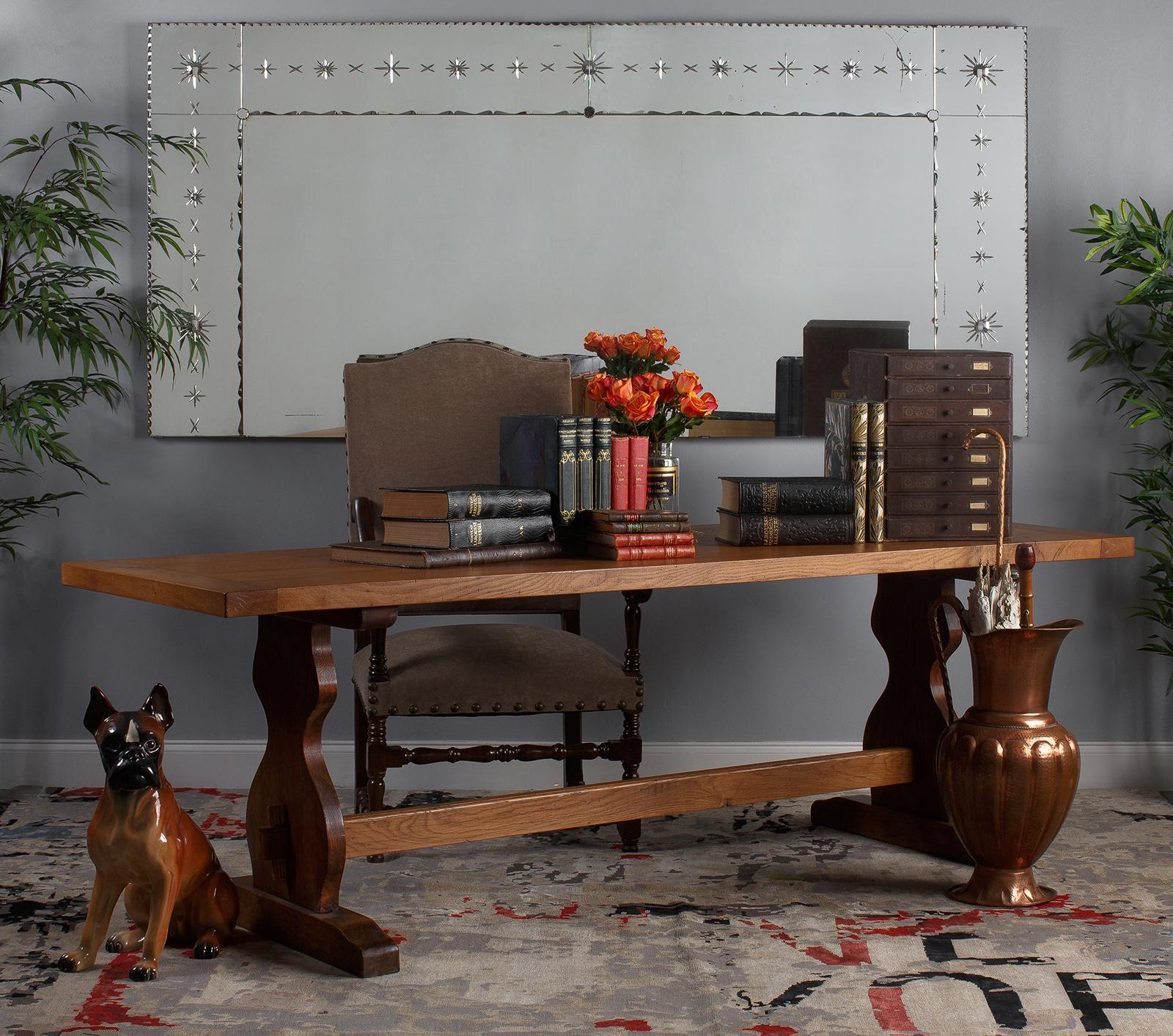 A very large Venetian cut-glass mirror from Lyon, circa 1950. One sizable center mirror is hemmed in by two long side panels and two horizontal panels at the top. The panels are joined by three round mirrored connectors with tiny scalloped edging,